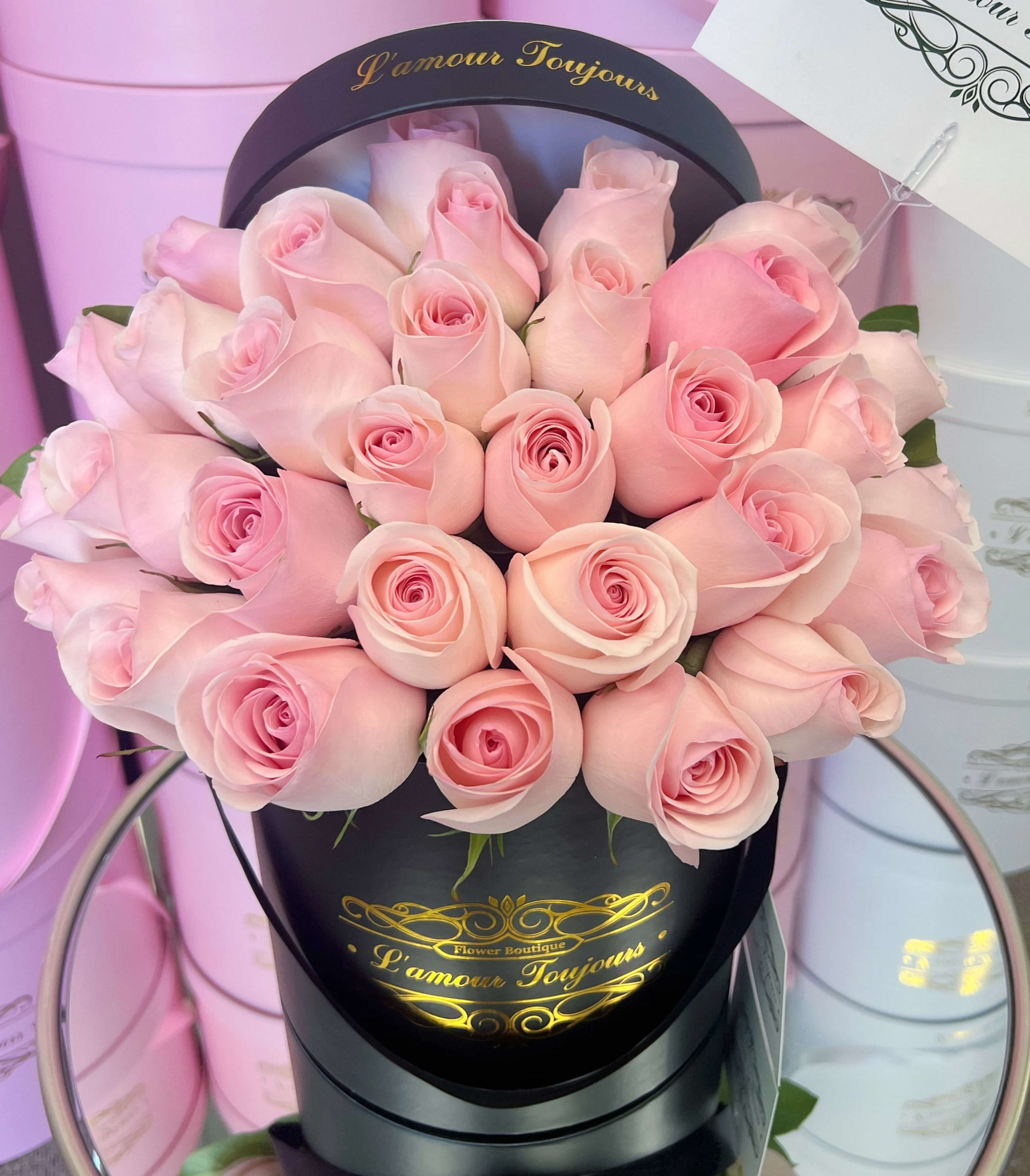 Bouquet of pale pink roses in a black round box