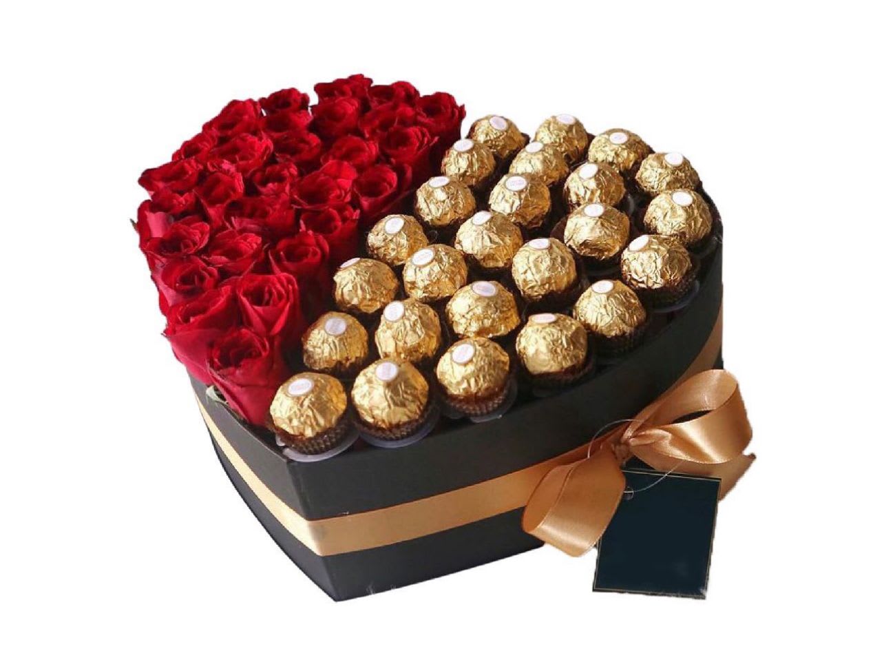 Sweetest Heart - Description: Show your love with "Sweetest Heart," a romantic gift perfectly packaged.  This heart-shaped box contains a breathtaking arrangement of red roses and a selection of exquisite Ferrero Rocher chocolates – a delightful combination of beauty and deliciousness.  * heart shape box color may vary due to availability. leave a comment in instructions if you have a preference. 