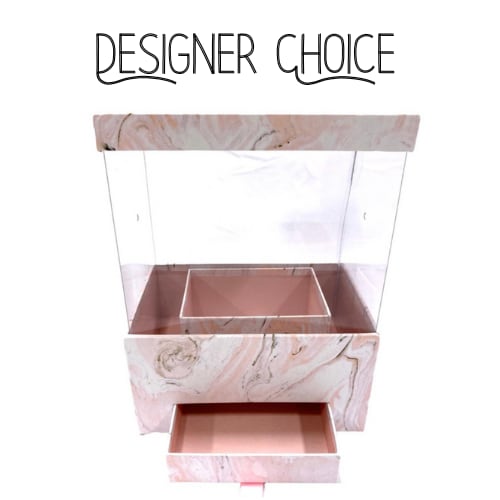 Designer Choice - Pink Marble Secret - Indulge in the ultimate expression of elegance with our Designer's Choice arrangement.  A curated selection of the freshest, most exquisite blooms is artfully arranged and presented in a sleek, Pink Marble Secret gift box.  Hidden within, a secret drawer reveals a delightful assortment of fine chocolates, creating a truly luxurious and unforgettable gift experience.  This is more than just flowers; it's a statement of refined taste.  *Please let us know if you have a floral color preference. We will choose florals to compliment the box