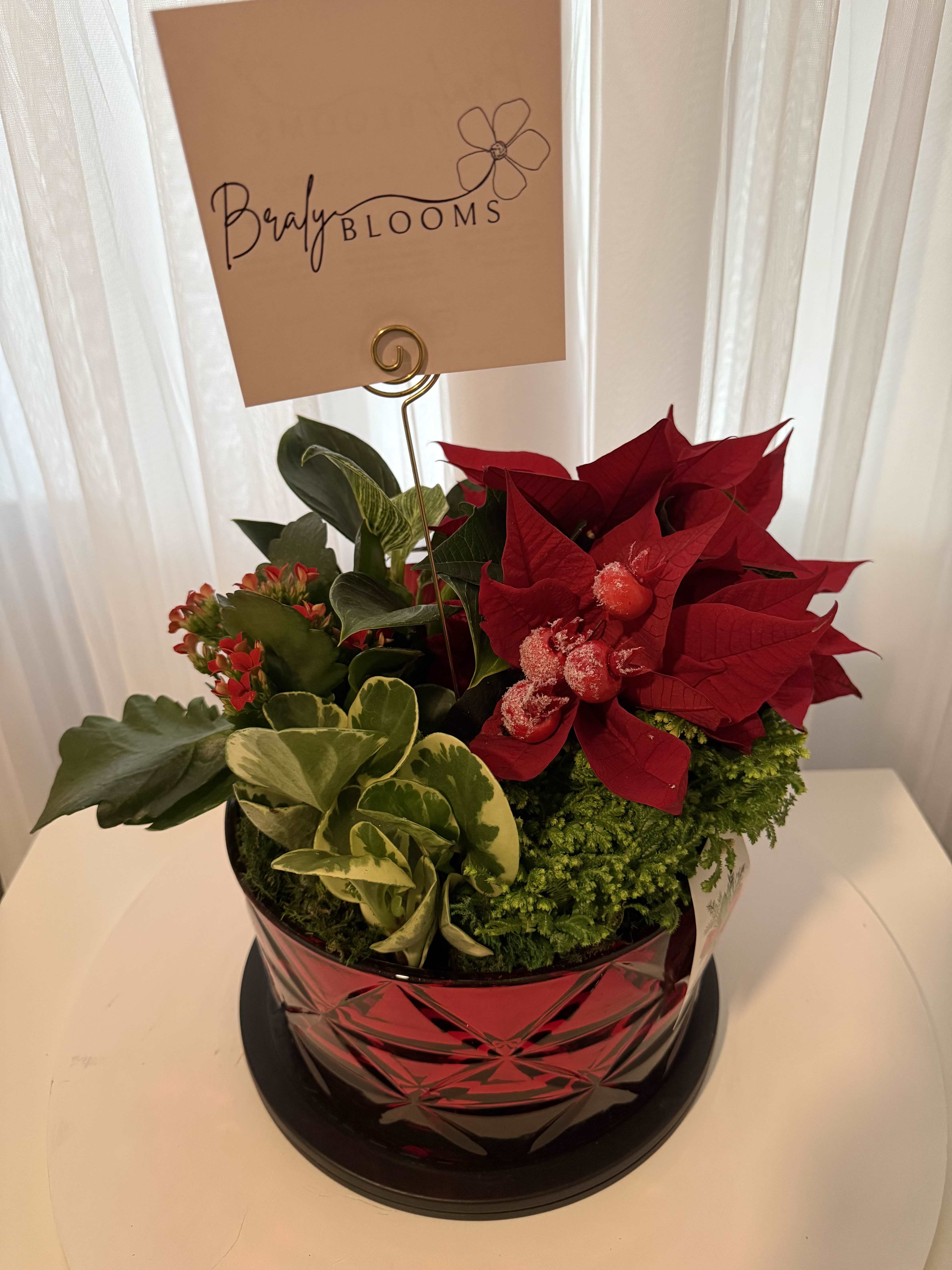 Yuletide Elegance Arrangement - Celebrate the season with our Holiday Hearth Arrangement, thoughtfully designed with fragrant Christmas greens, rich poinsettias, and festive berries. This classic holiday design brings warmth and elegance to any table or space, creating a welcoming focal point for seasonal gatherings and celebrations.