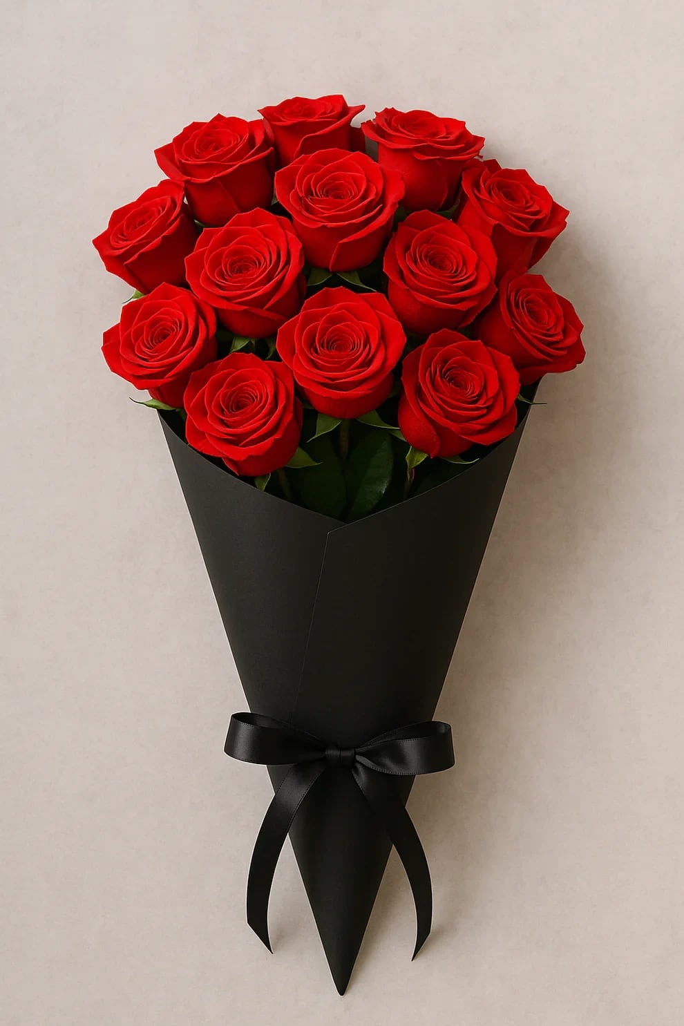 Bouquet of red roses wrapped in black paper with a black ribbon