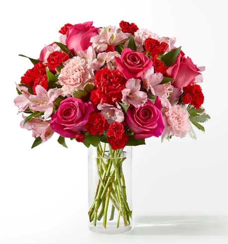 Pink and red mixed bouquet in a clear glass vase