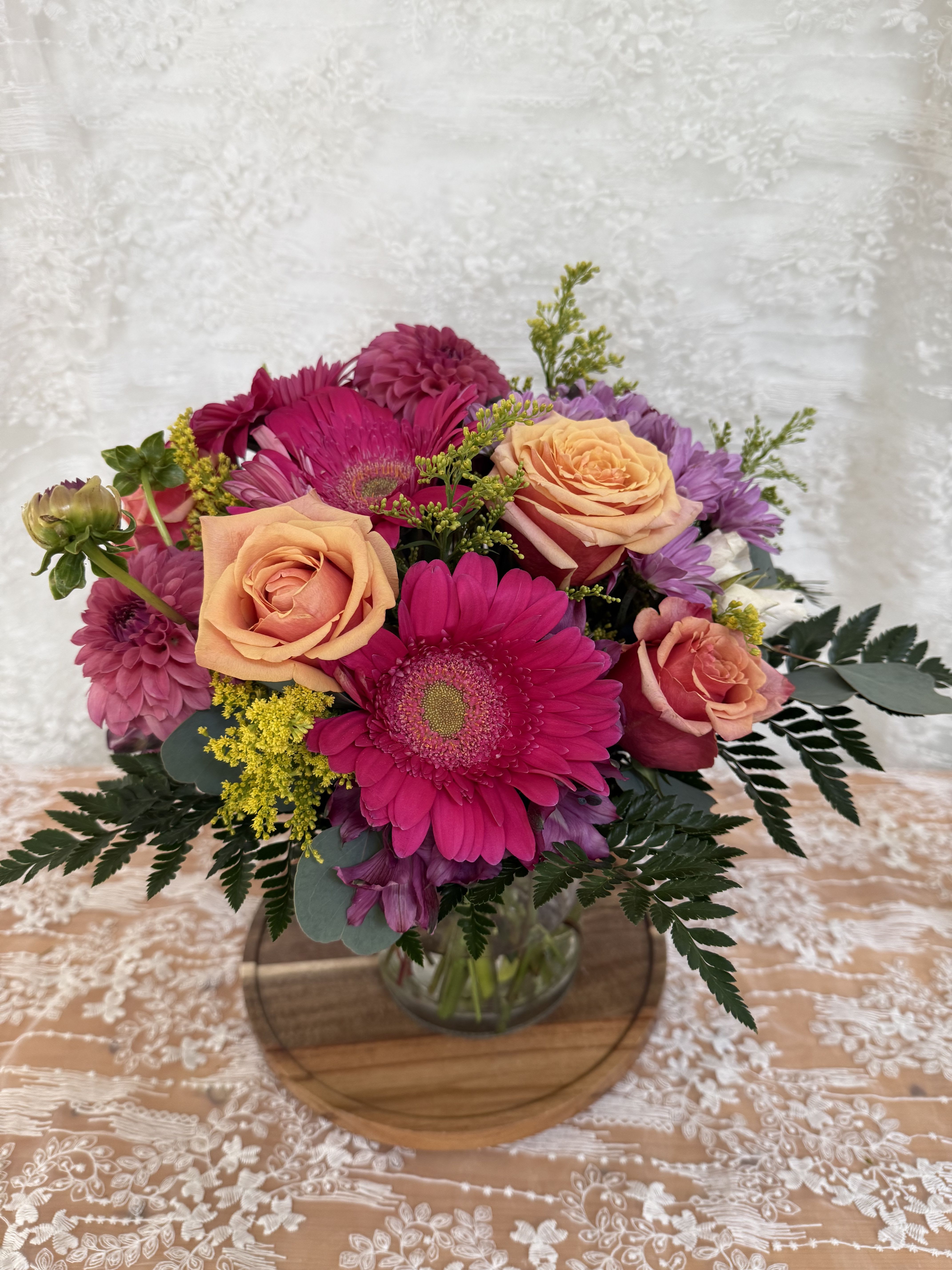Summer Daisy - Arrangement filled with summer florals  Roses, Dahlias and Daisies  If a particular flower, is unavailable, an item of similar quality and value will be substituted.
