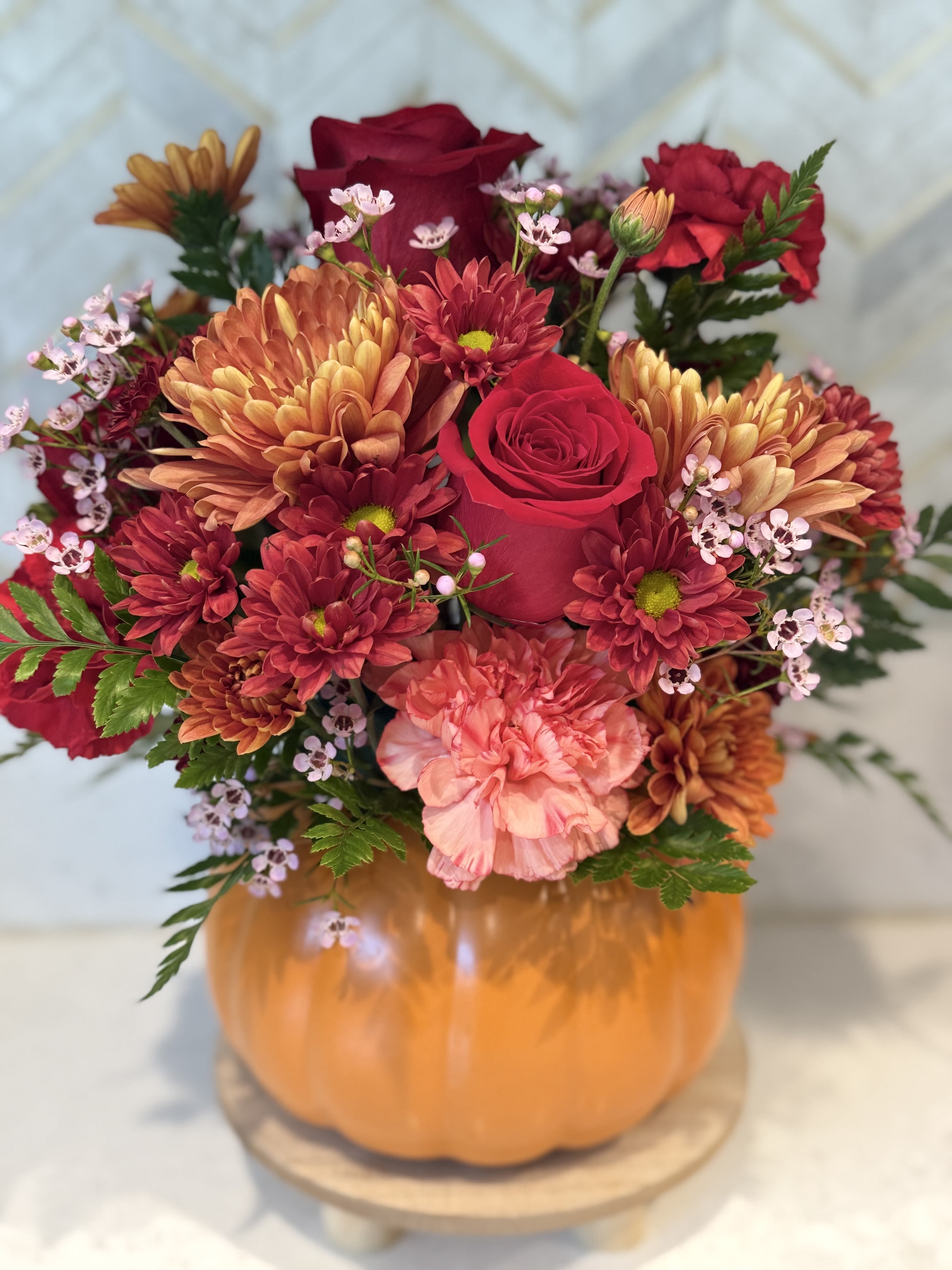 Trick or Treat - Designers' choice. Fall pumpkin flower arrangement   Pumpkin will be filled with in stock fall flowers.    If a particular flower, is unavailable, an item of similar quality and value will be substituted.