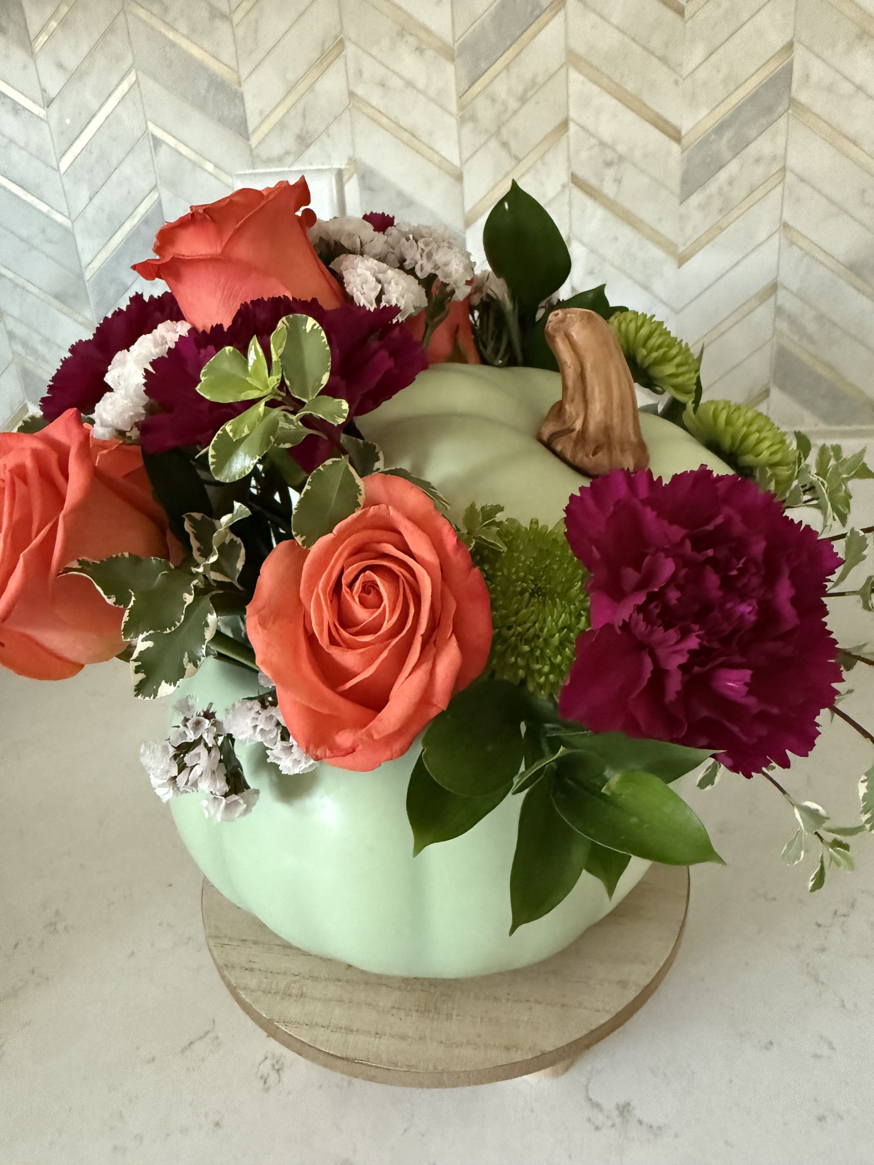 Sage pumpkin  - Designers choice sage pumpkin with fall flowers  Ceramic pumpkin will filled with in stock fall flowers   If a particular flower, is unavailable, an item of similar quality and value will be substituted.