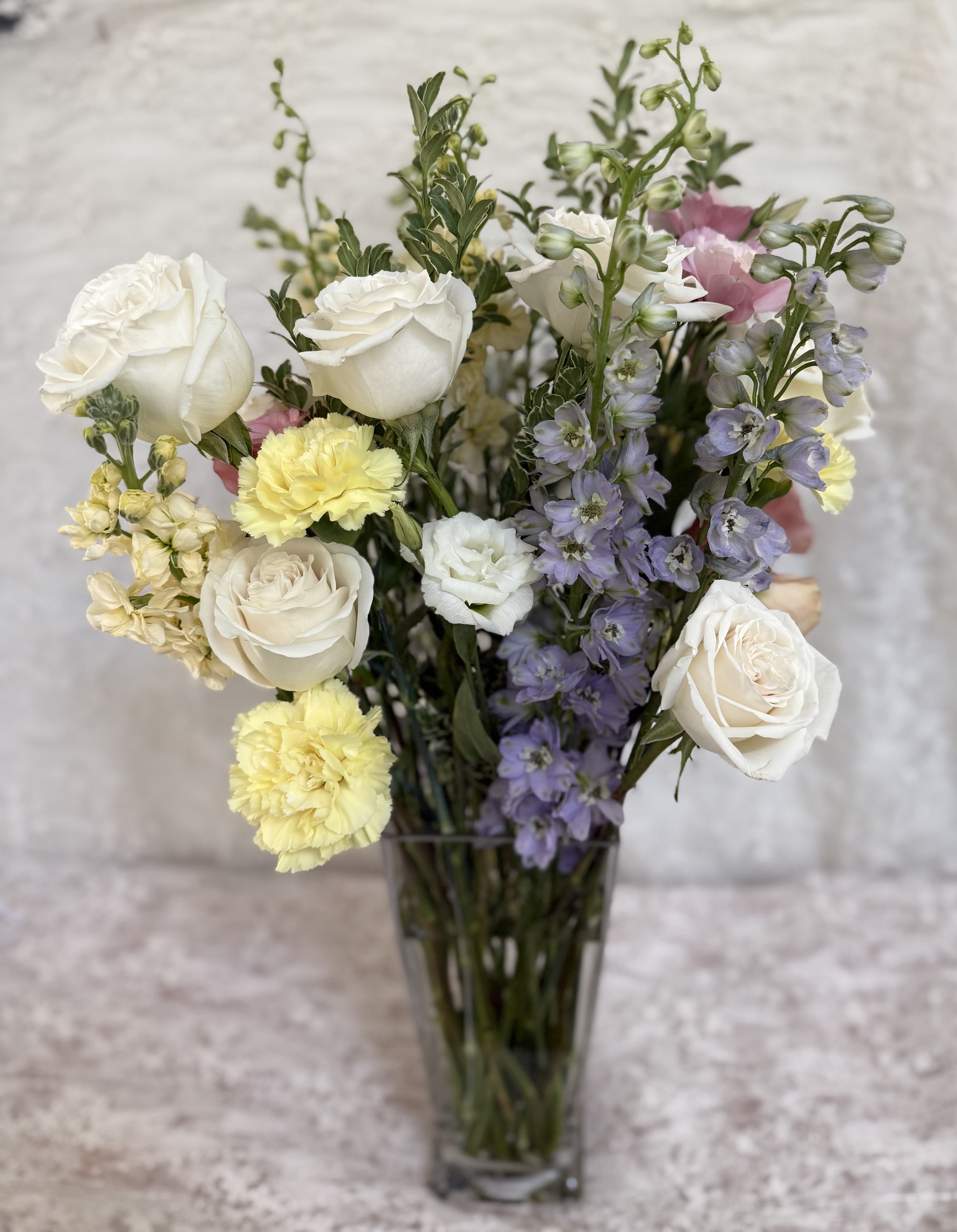 Delphinium Bloom - Tall 20 inch mix flower bouquet  Delphinium, roses, carnations, stock and lisianthus.   If a particular flower, is unavailable, an item of similar quality and value will be substituted.
