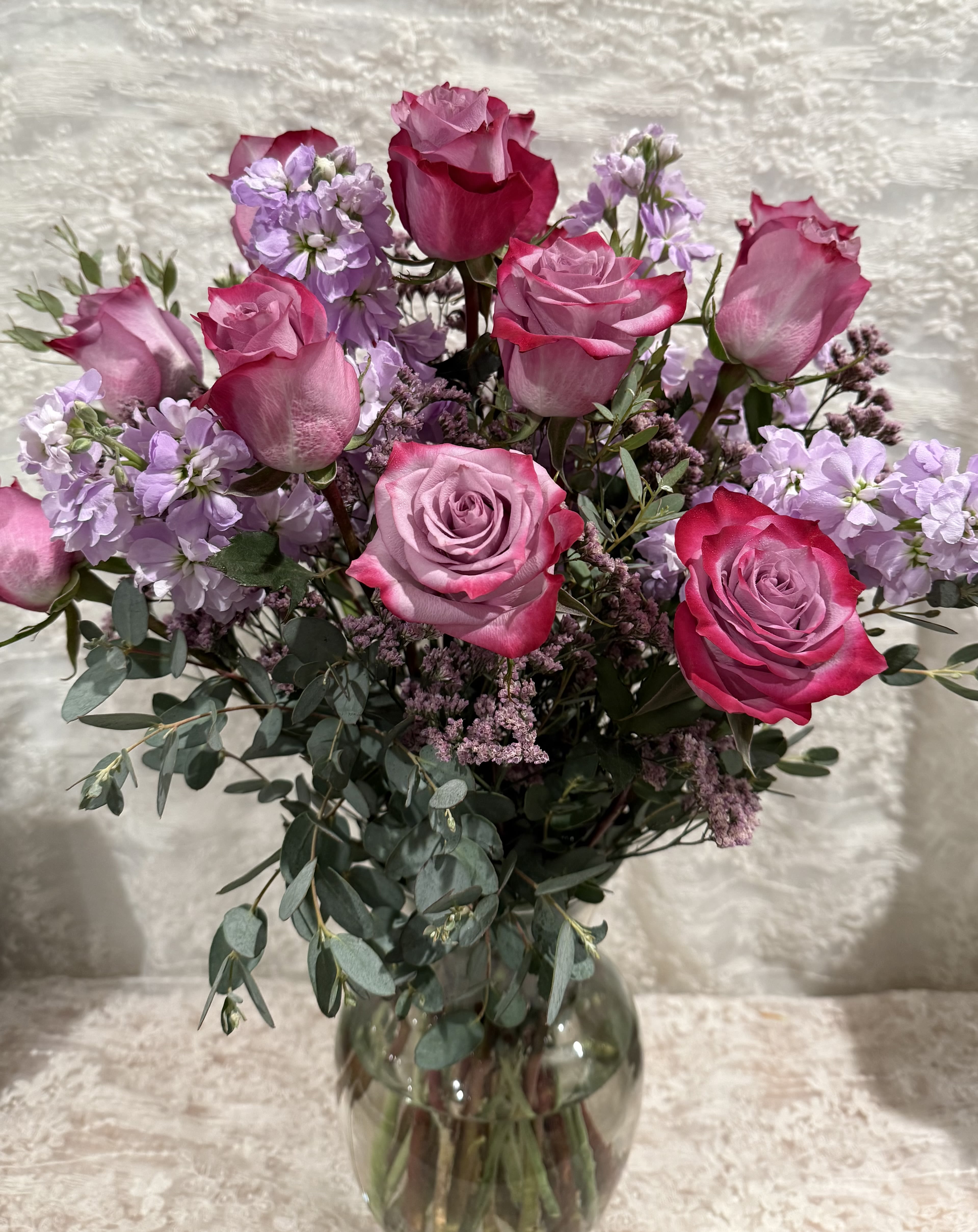 Lavender Love - One dozen lavender roses with lavender stock and eucalyptus.  If a particular flower, is unavailable, an item of similar quality and value will be substituted