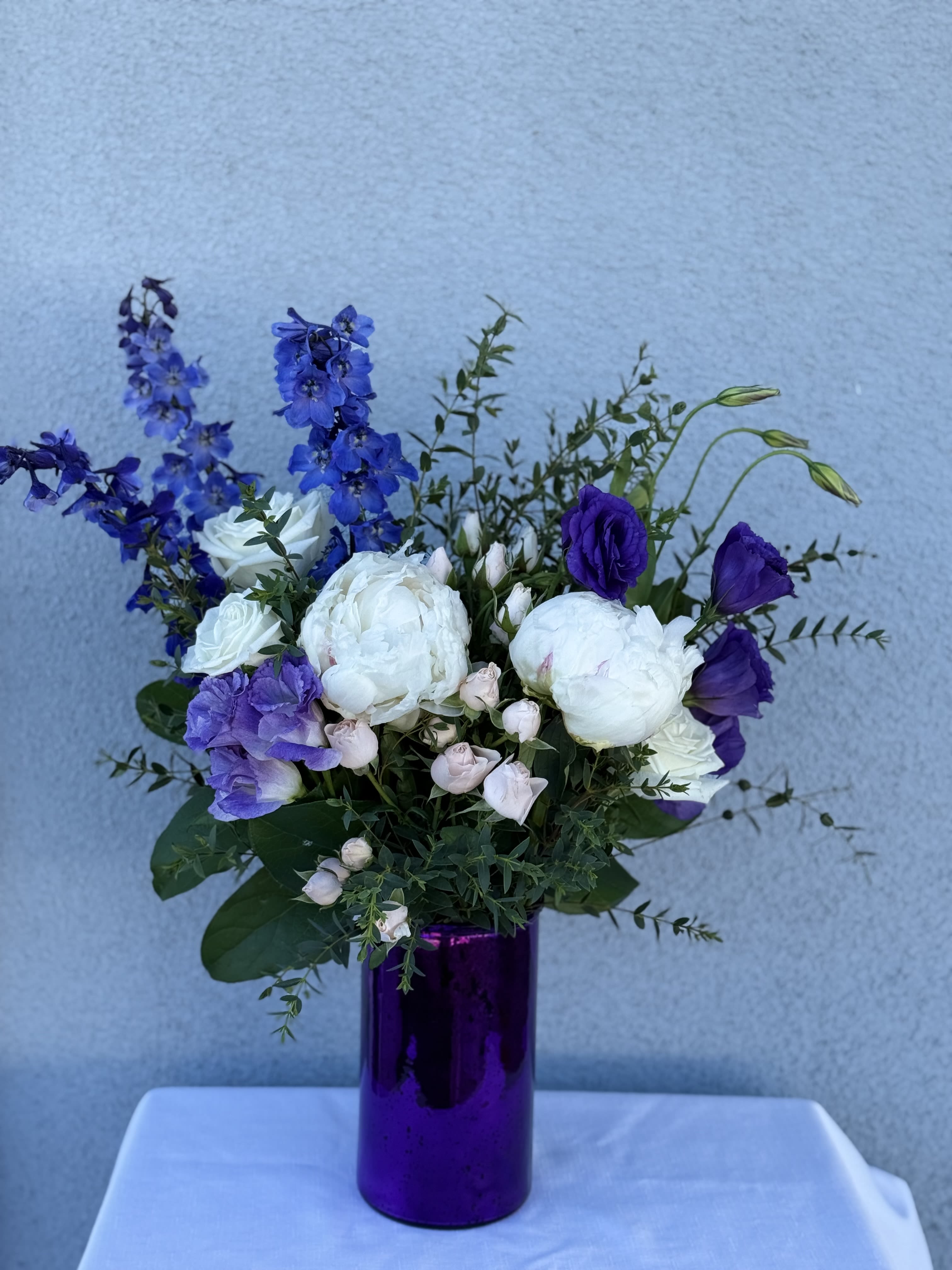 Lavender Magic - Purple arrangement  Roses Lisianthus Peonies Eucalyptus   If a particular flower, is unavailable, an item of similar quality and value will be substituted