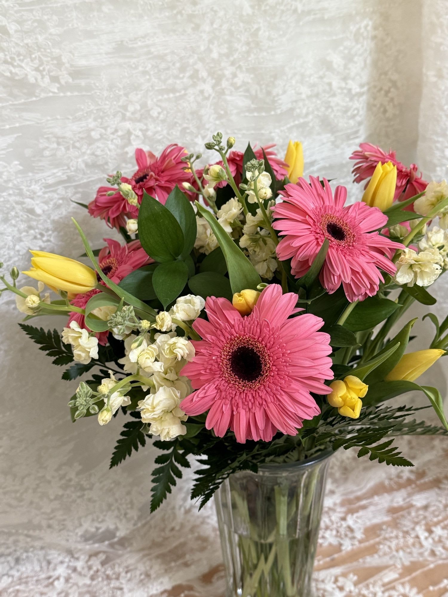 Spring Bloom - A mixture of daisies and tulips with stock line flowers.
