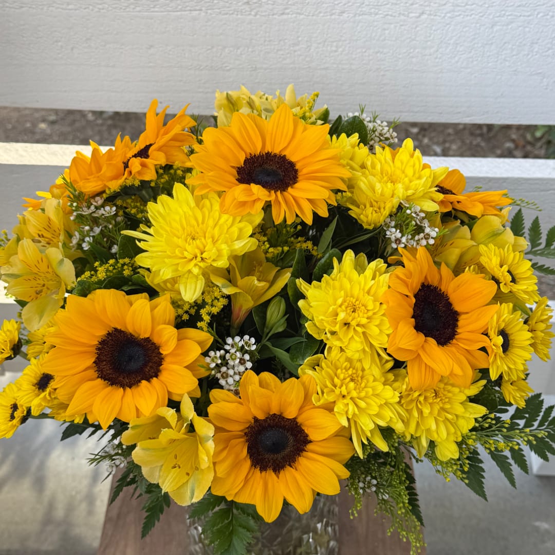 Yellow and orange sunflower bouquet in a glass vase