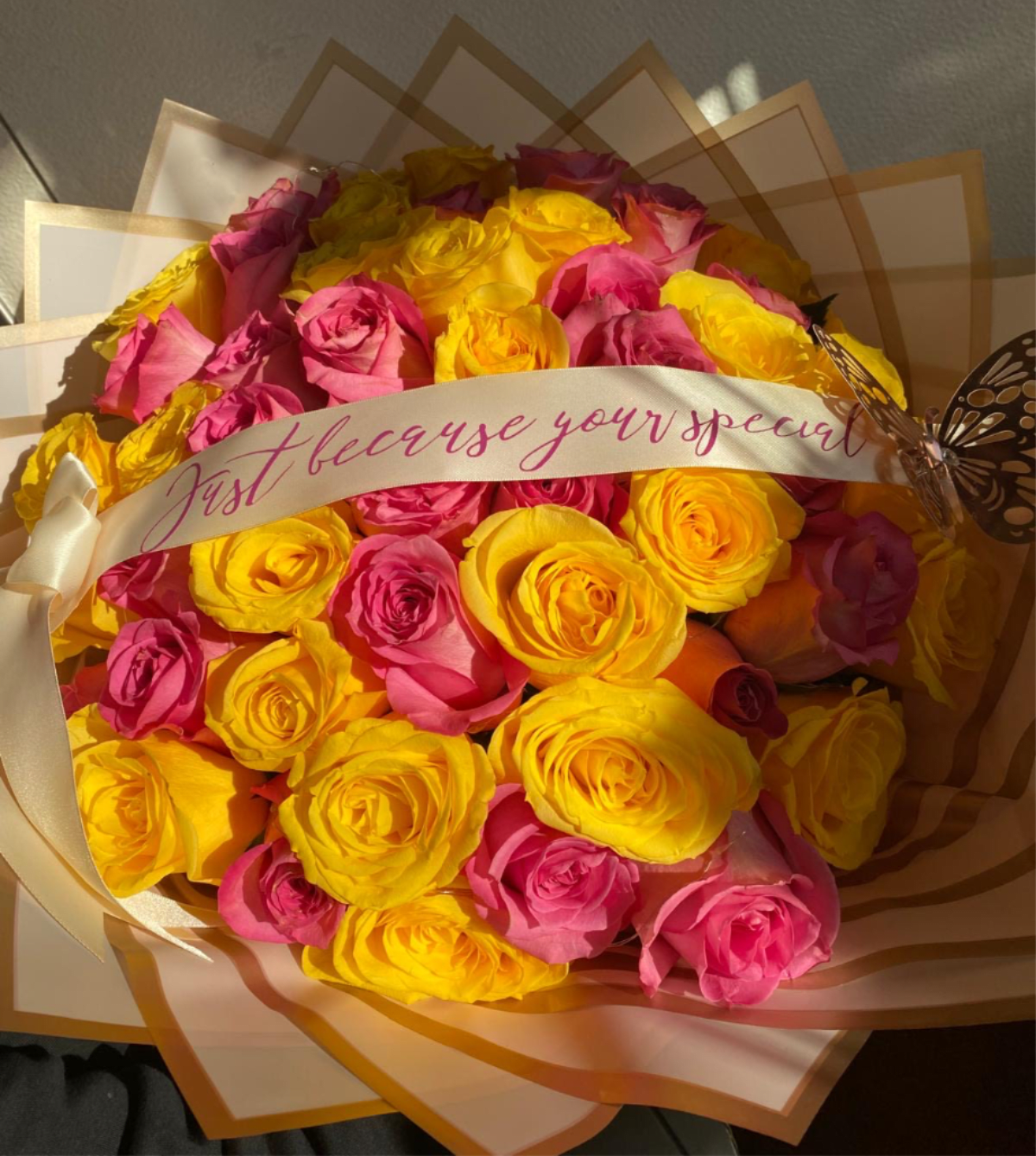 Sunshine Kisses Bouquet - A bright and joyful bouquet featuring a vibrant mix of brilliant yellow and striking hot pink roses. Elegantly wrapped and tied with a ribbon bearing the sweet message of your choosing! This arrangement is pure, cheerful delight.