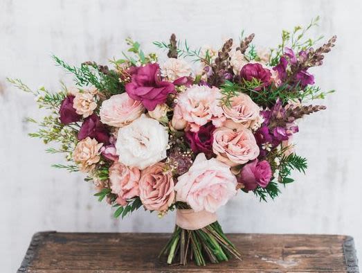 Bouquet of blush and magenta roses with mixed greenery