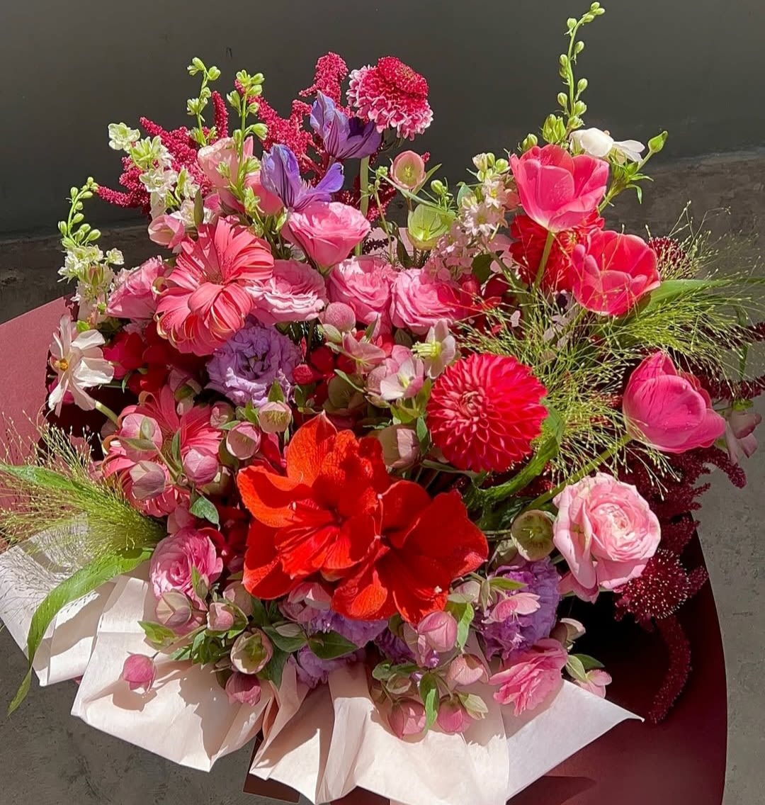 Bright mixed bouquet of pink, red, purple, and white flowers