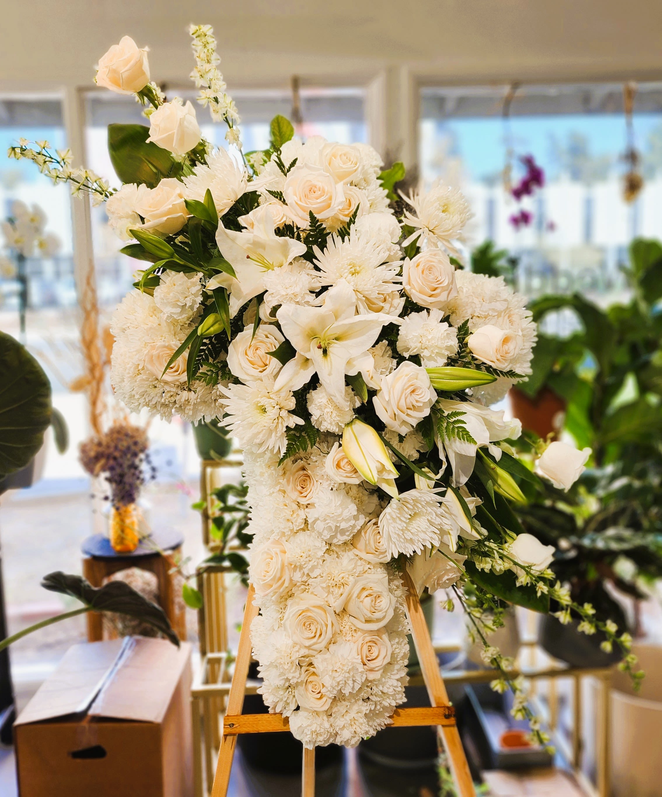 Large white floral standing spray on an easel