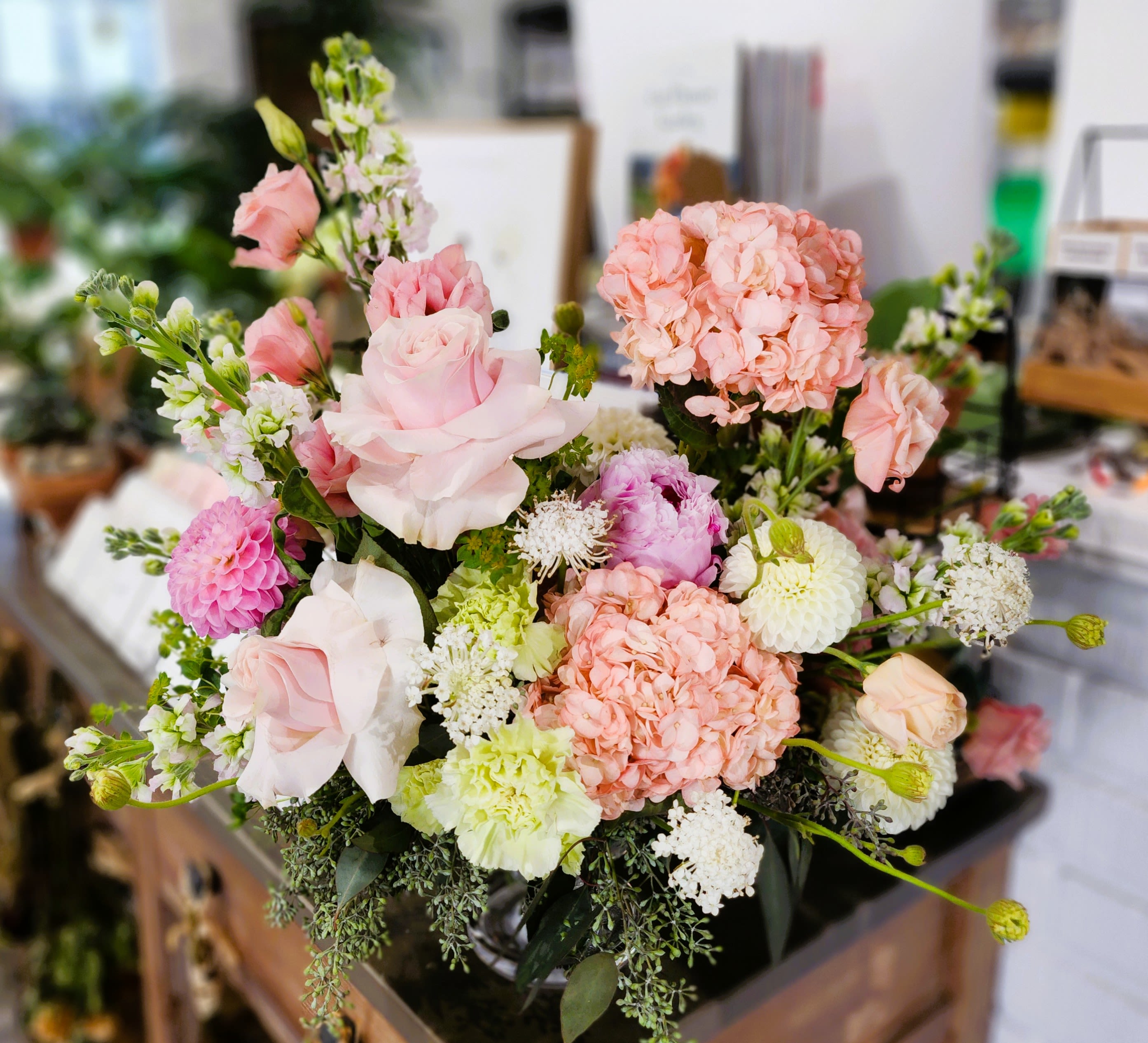 Pink and white mixed bouquet with hydrangeas, roses, and other blooms