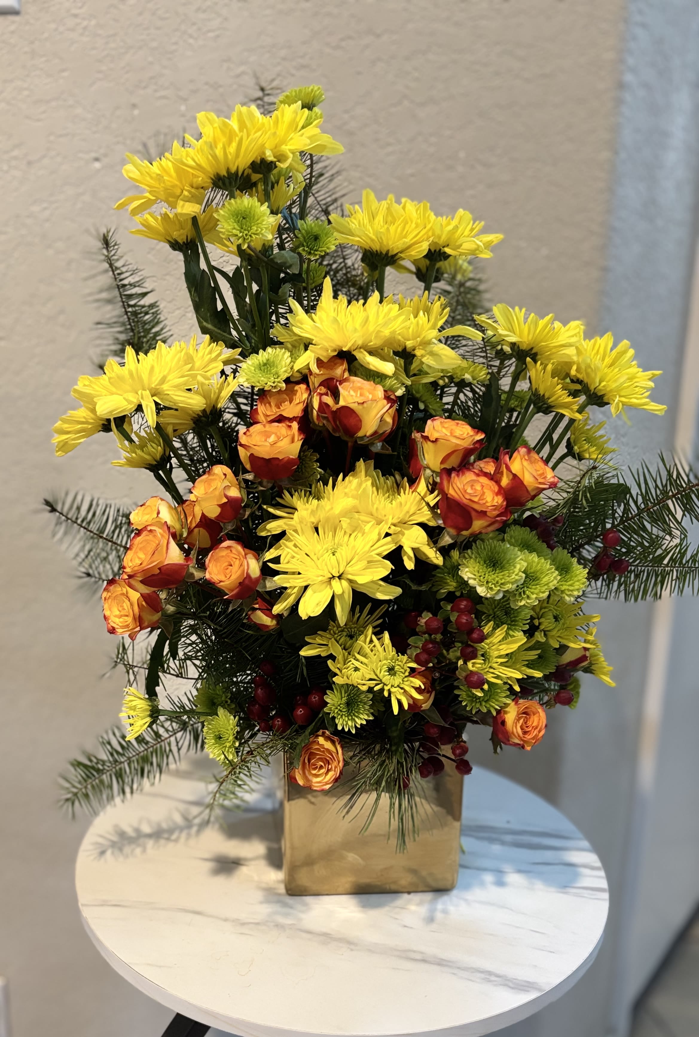 Golden Sunshine  - Golden Sunshine Garden is a bright and cheerful floral arrangement featuring yellow chrysanthemums, orange spray roses, green button mums, seasonal berries and textured greenery in a modern container. Handcrafted by Snyder Flowers, a local florist in San Antonio, this colorful design is perfect for birthday flowers, congratulations, thank-you gifts, housewarming celebrations, fall occasions or simply sending someone a little sunshine. Its warm yellow, orange and green tones create an uplifting floral gift for customers searching for fresh flower delivery in San Antonio. Snyder Flowers offers local flower delivery throughout San Antonio, Helotes, Leon Valley, Live Oak and Schertz, with same-day flower delivery available on select orders.