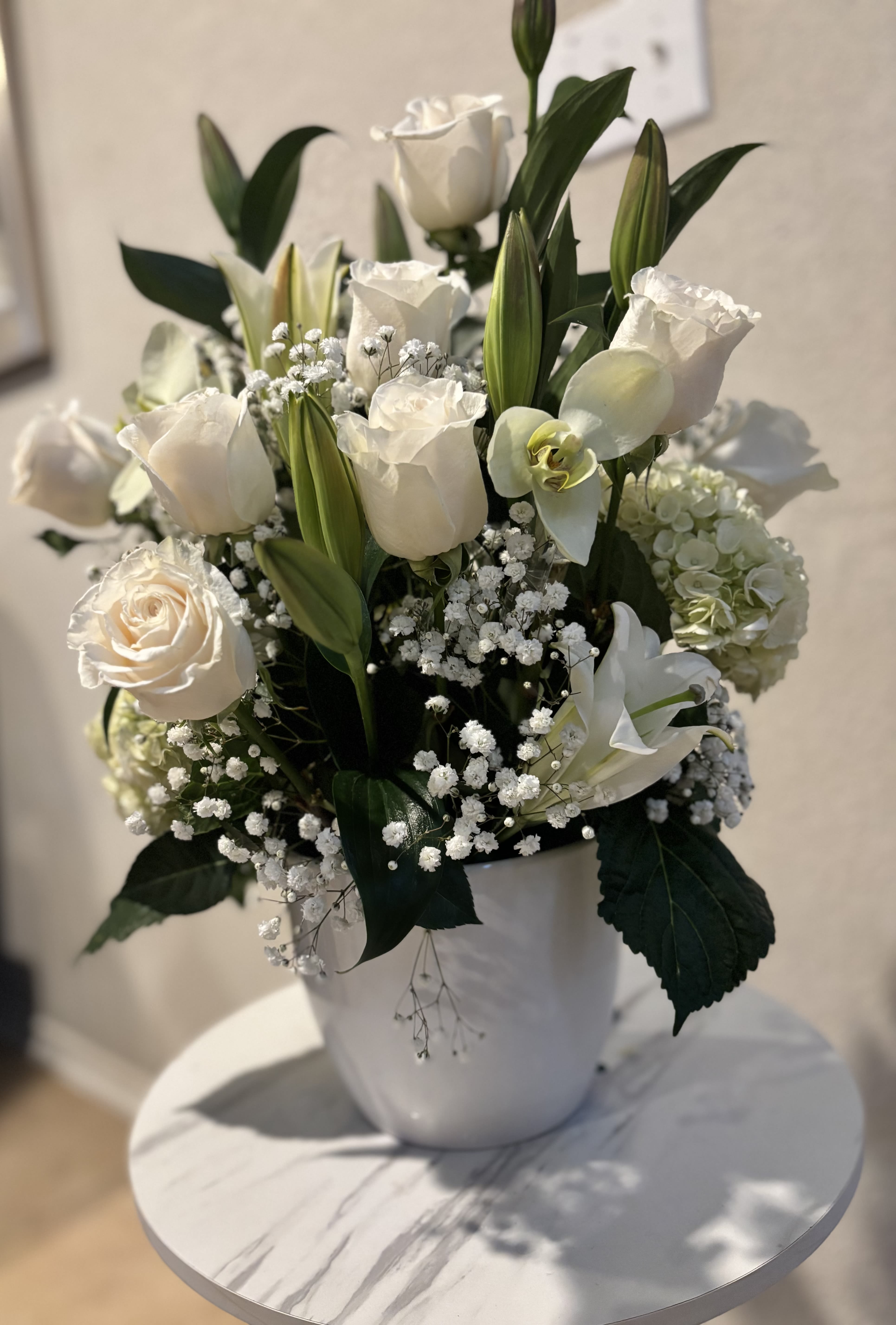 Pure Elegance - Elegant white flower arrangement by Snyder Flowers in San Antonio featuring white roses, lilies, hydrangeas and baby’s breath with fresh greenery and same day delivery perfect for sympathy, anniversaries and special occasions