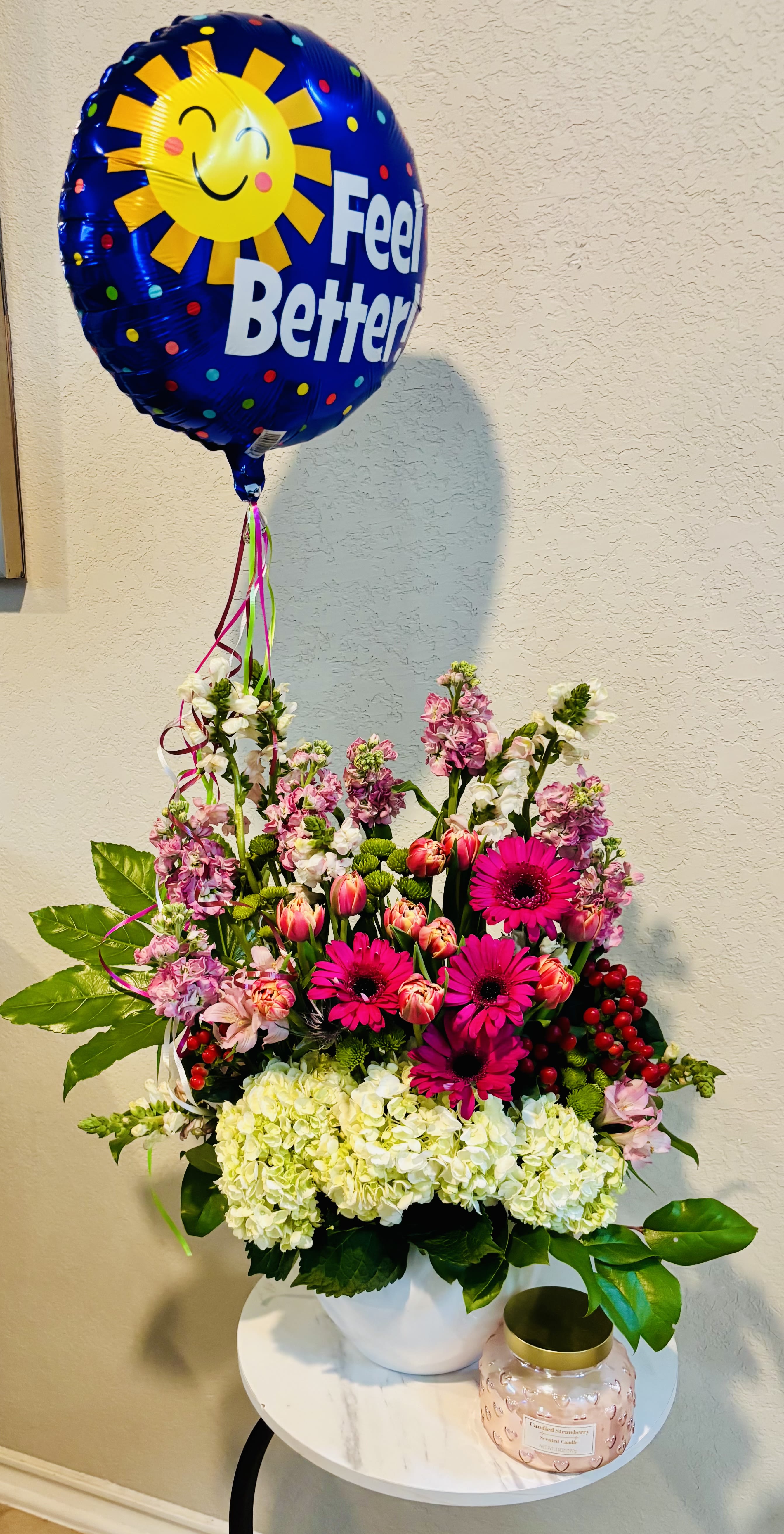 Get Well Sunshine - Bright Get Well Garden is a cheerful floral arrangement designed with pink gerbera daisies, white hydrangea, tulips, stock flowers and colorful seasonal blooms, finished with a “Feel Better” balloon. Handcrafted by Snyder Flowers, a local florist in San Antonio, this uplifting design is ideal for get well wishes, hospital flower delivery, recovery gifts, thinking of you occasions or sending encouragement to someone special. Its bright colors and comforting presentation make it a thoughtful choice for anyone searching for get well flowers in San Antonio. Snyder Flowers offers local flower delivery throughout San Antonio, Medical Center, Stone Oak, Live Oak and nearby areas, with same-day flower delivery available on select orders.