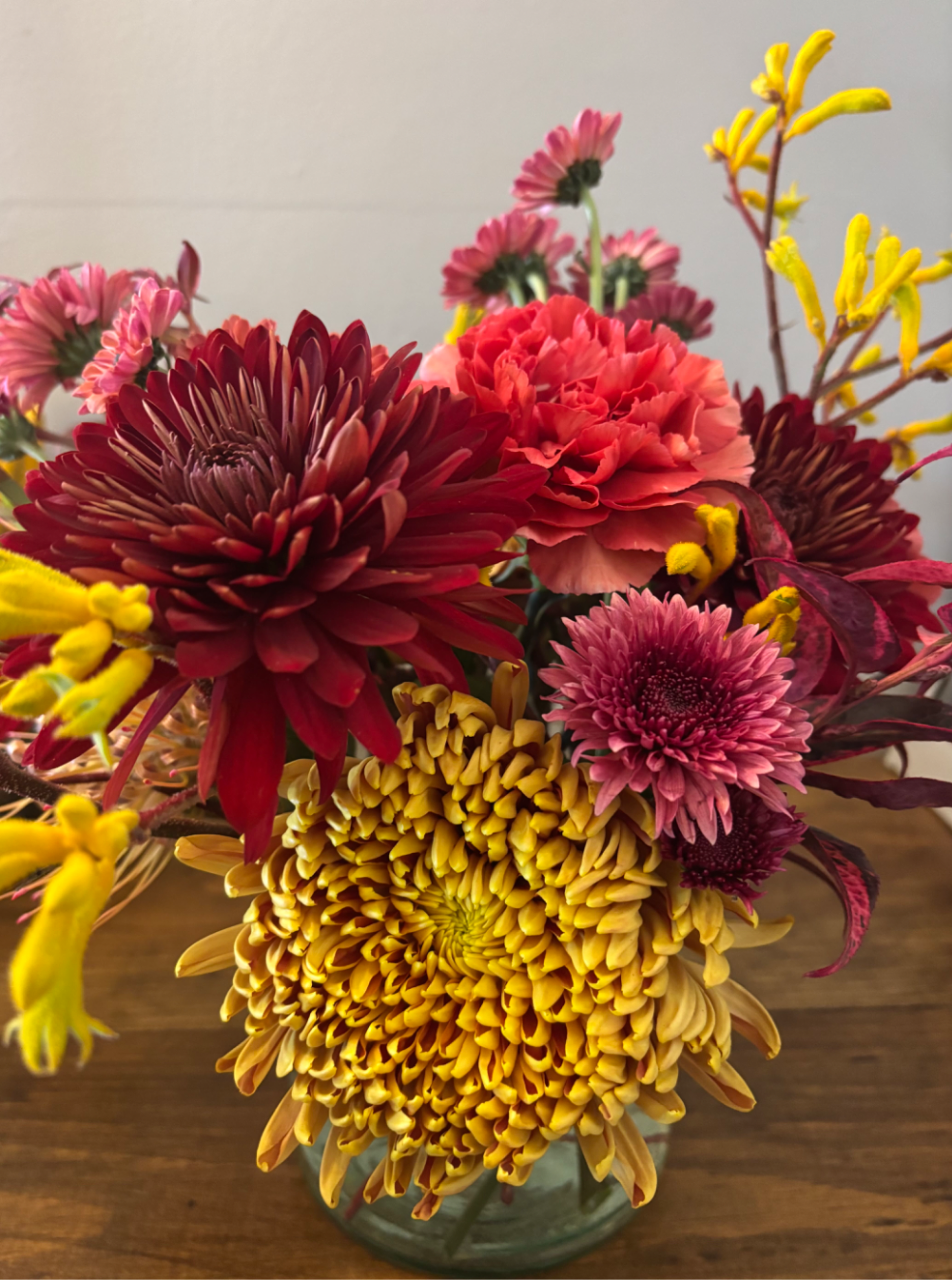 Colorful bouquet of chrysanthemums and carnations in a glass vase