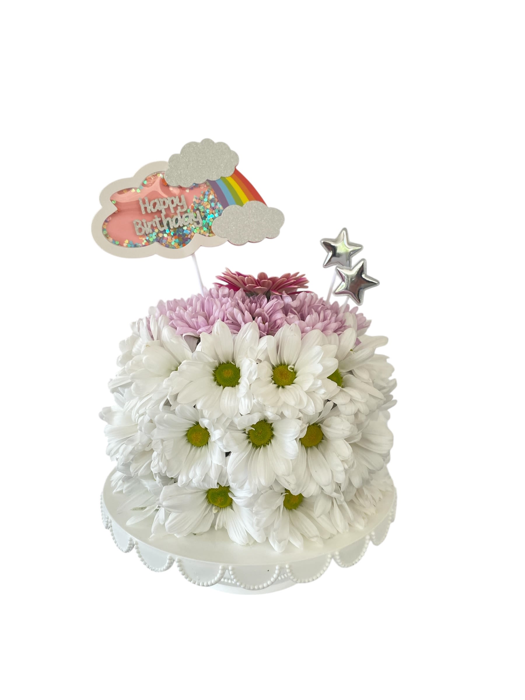 White daisy cake with pink flowers and birthday topper