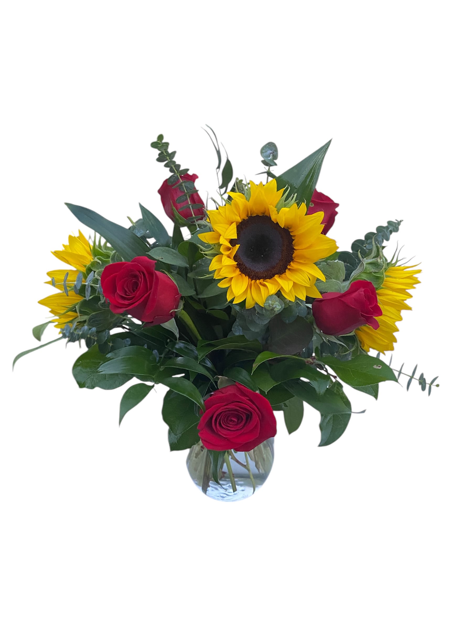 Red roses and sunflowers arranged in a clear glass vase