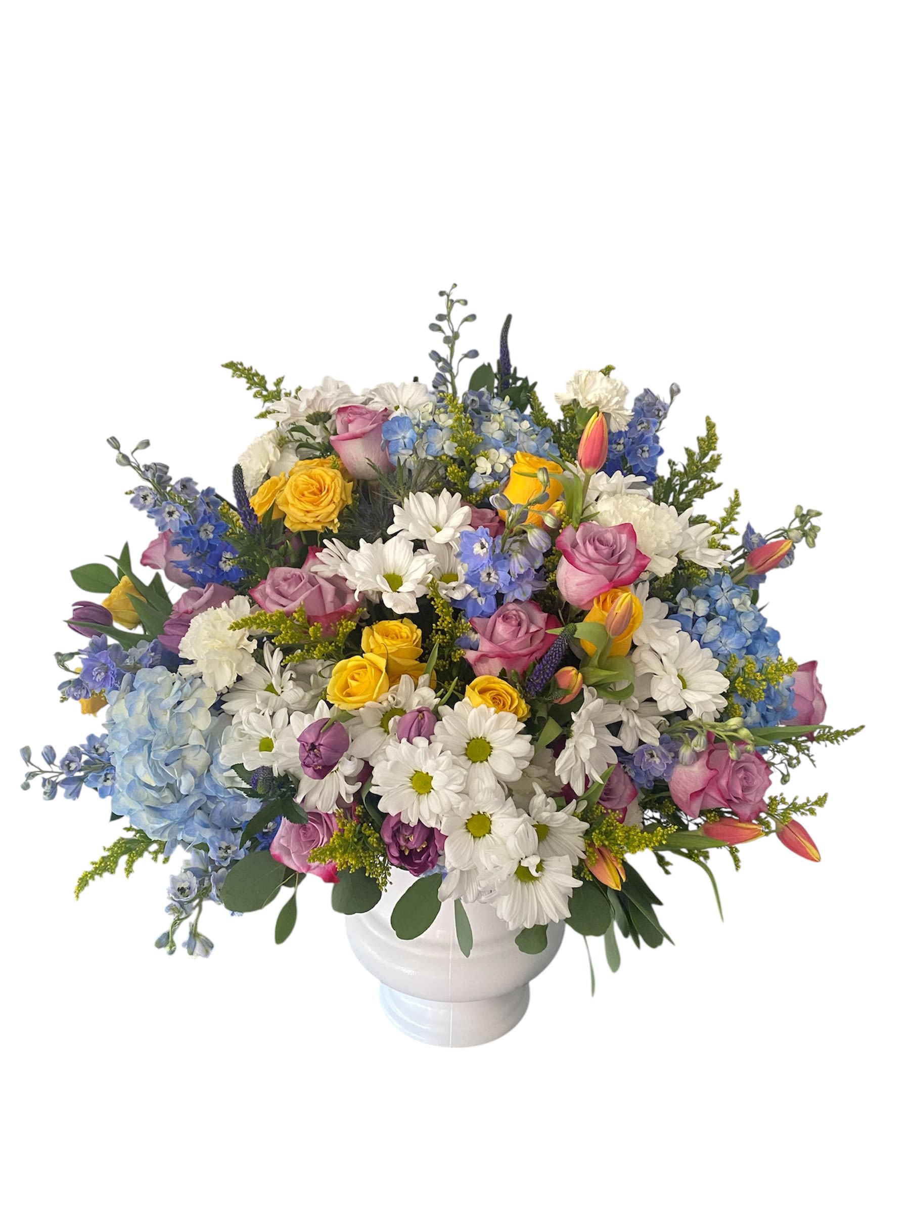 Mixed bouquet of roses, daisies, and hydrangeas in a white vase