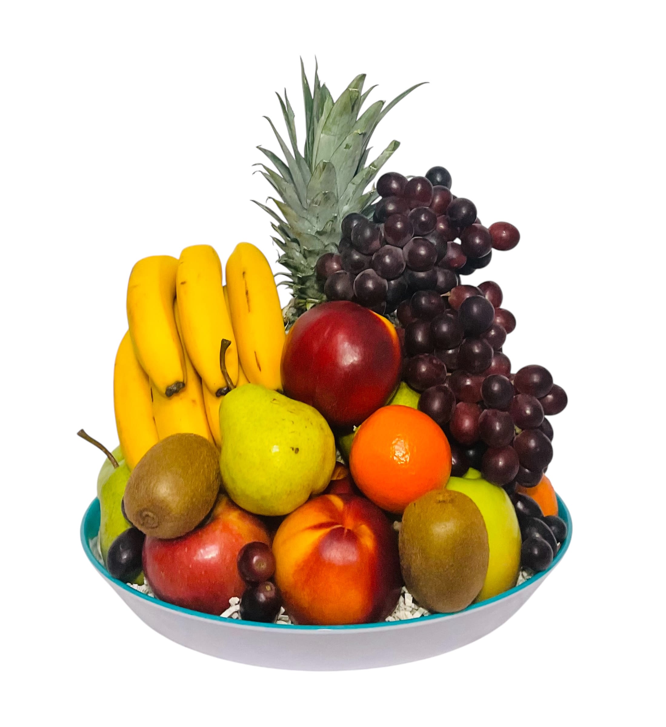 Fruit arrangement in a shallow bowl with bananas, grapes, pineapple, and assorted fruit