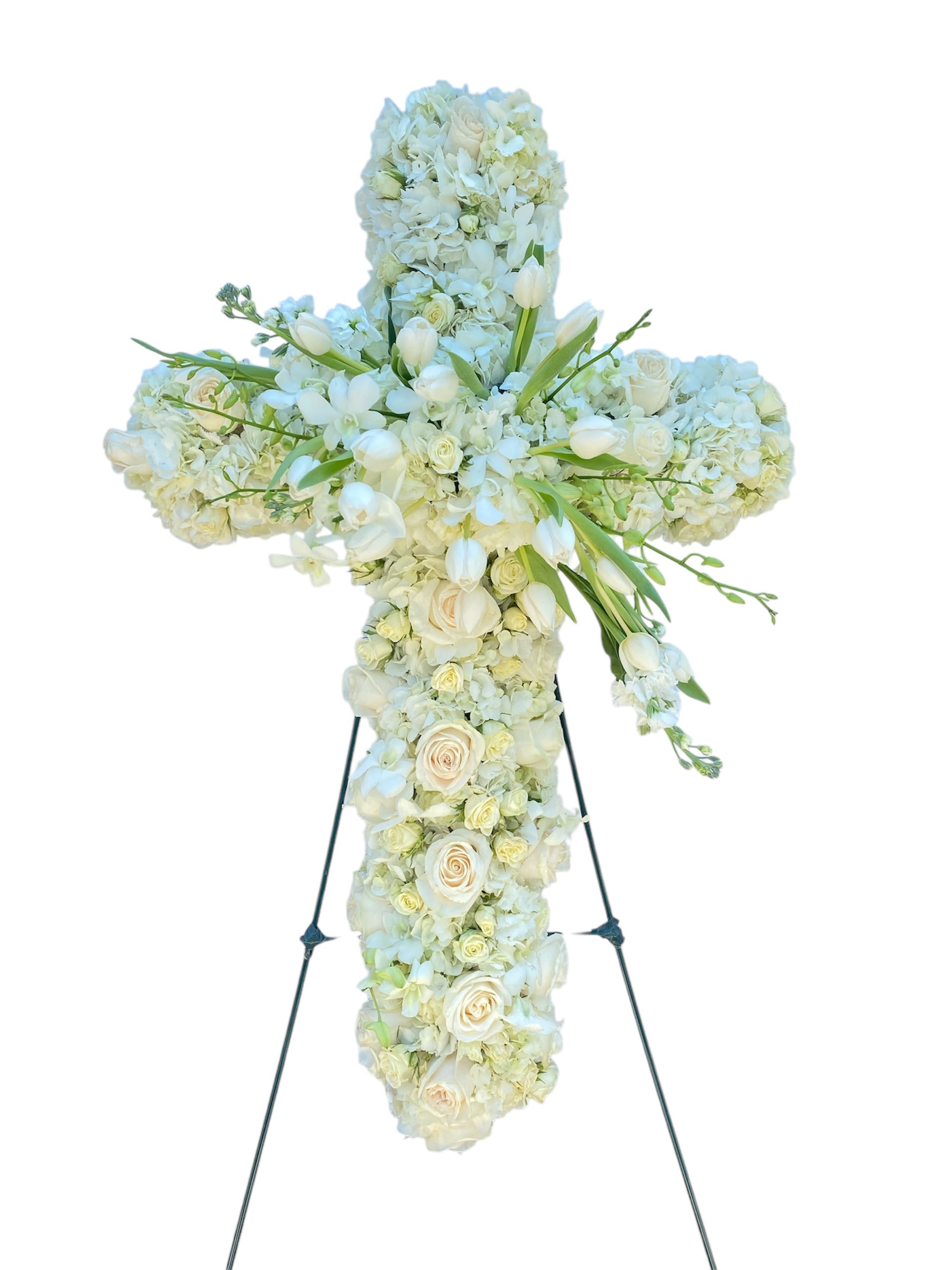 White floral cross on a stand with roses and hydrangeas
