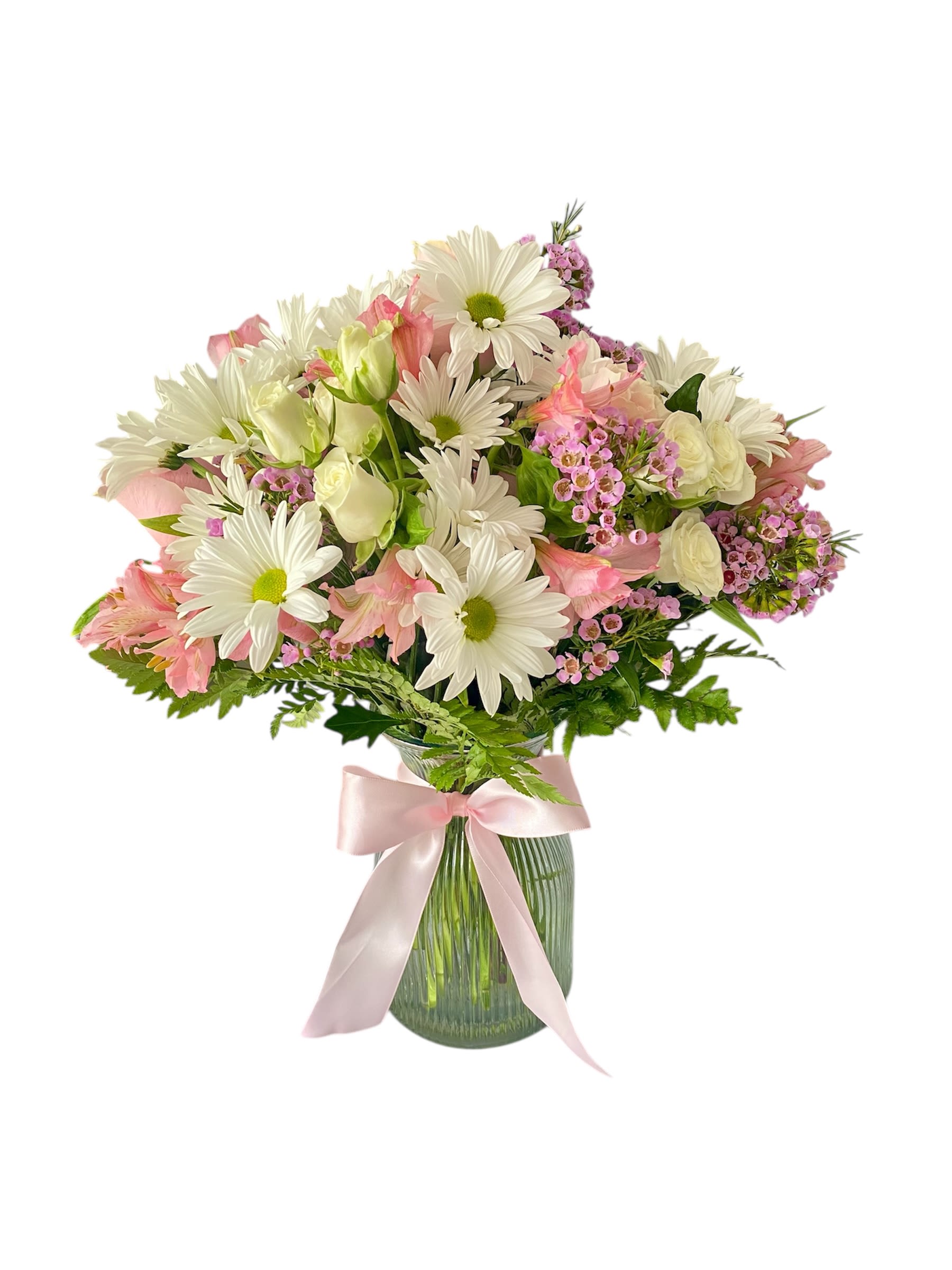 Pink and white mixed bouquet in a glass vase with a pink ribbon