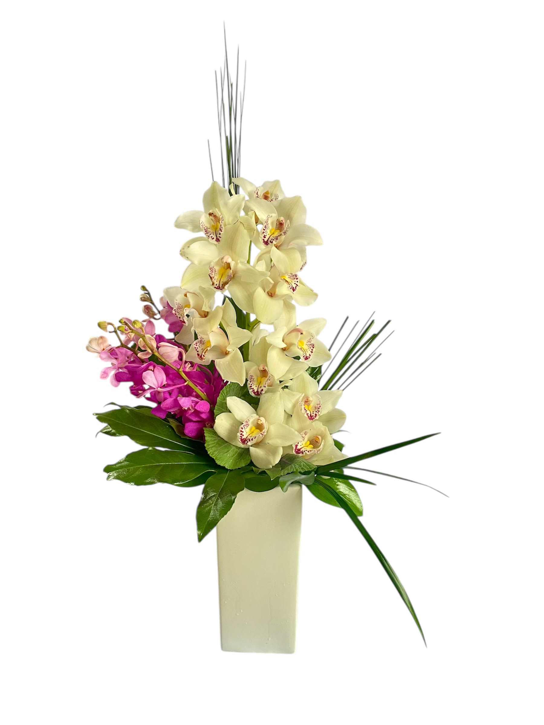 Tall orchid arrangement in a rectangular vase with cream and pink blooms