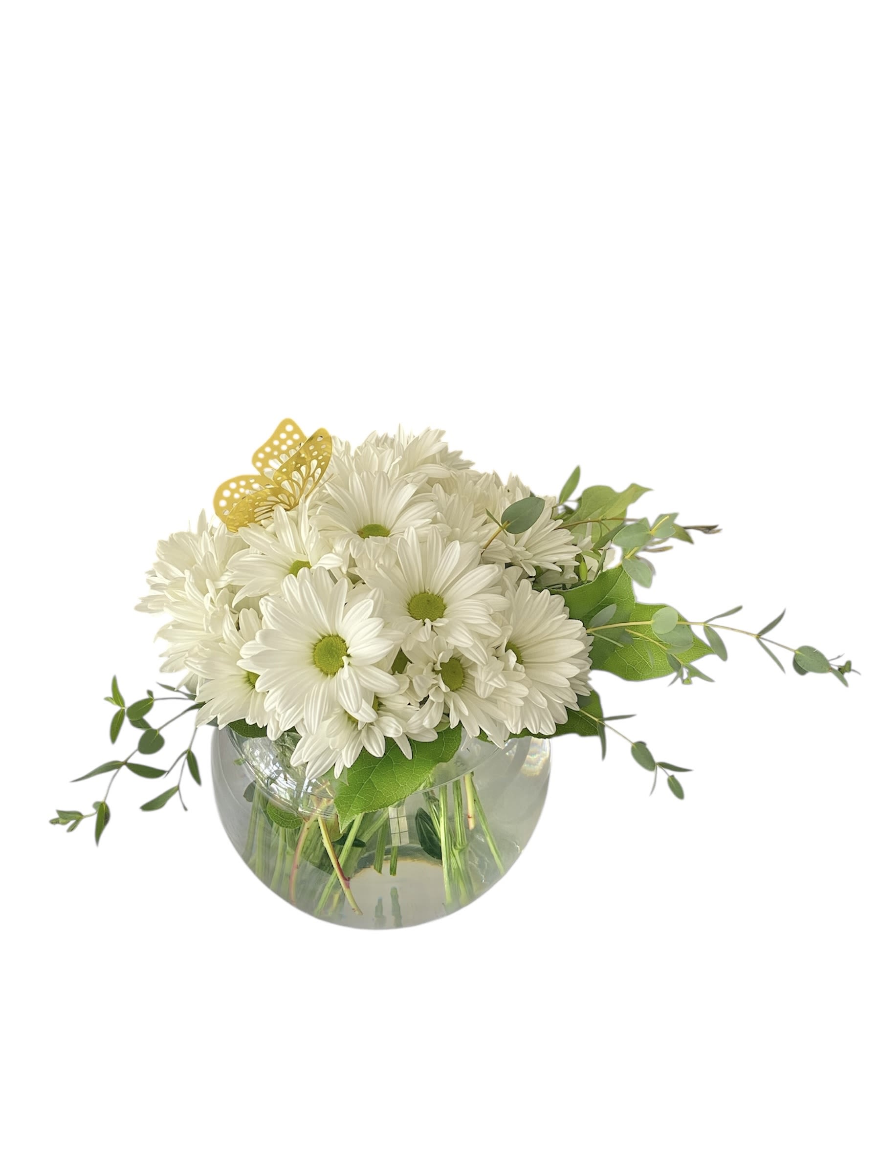 White daisy bouquet in a round glass vase with green foliage