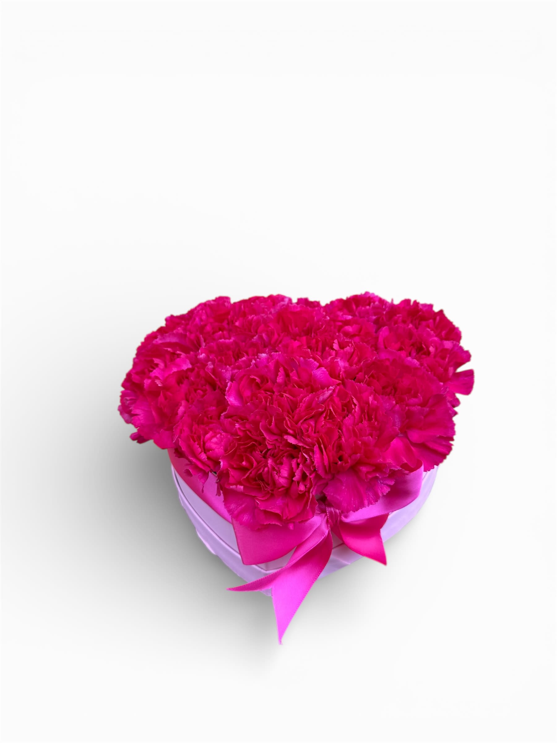 Hot pink carnation arrangement in a heart-shaped box with ribbon