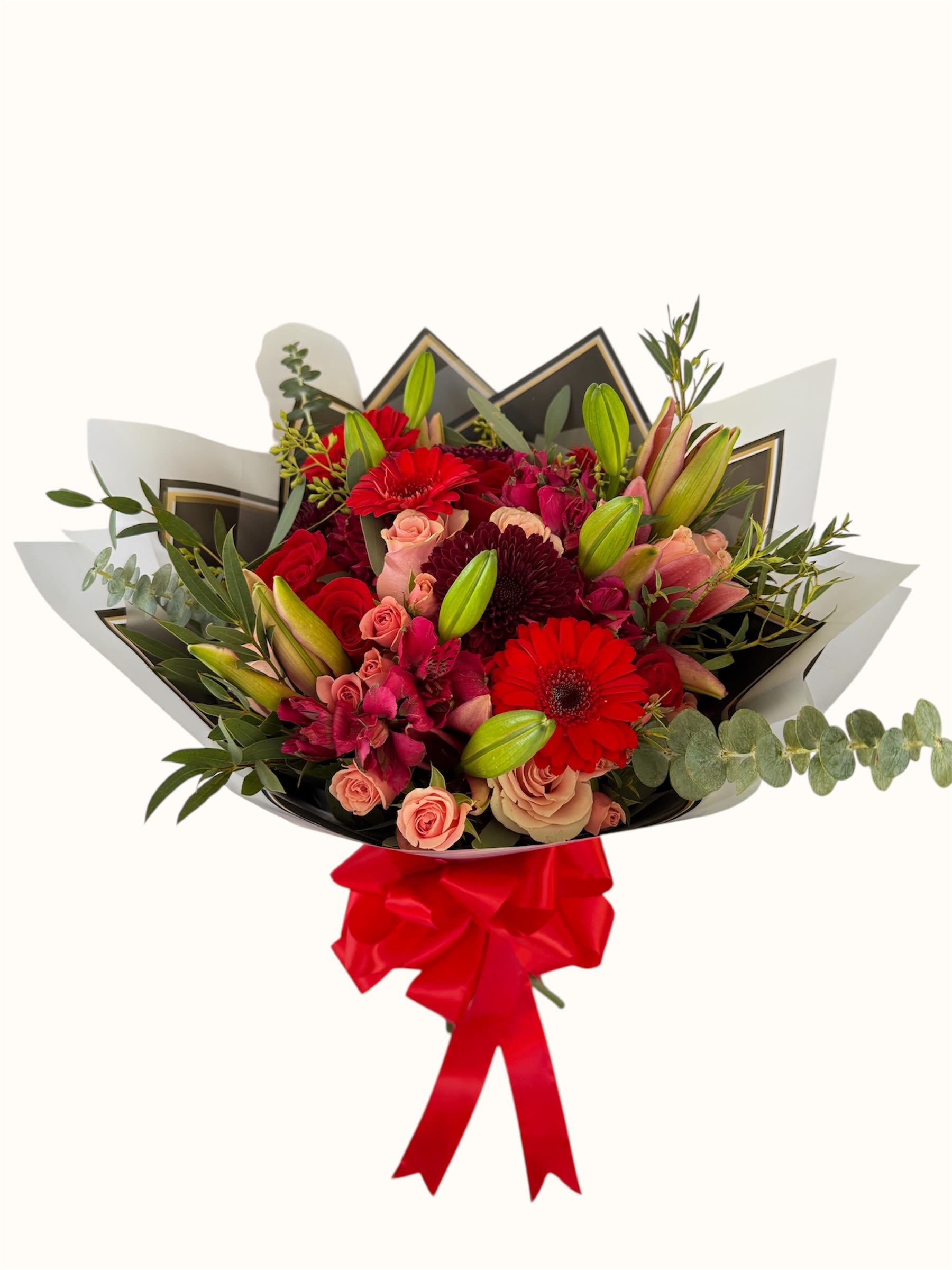 Bouquet of red and pink flowers wrapped with black paper and a red ribbon