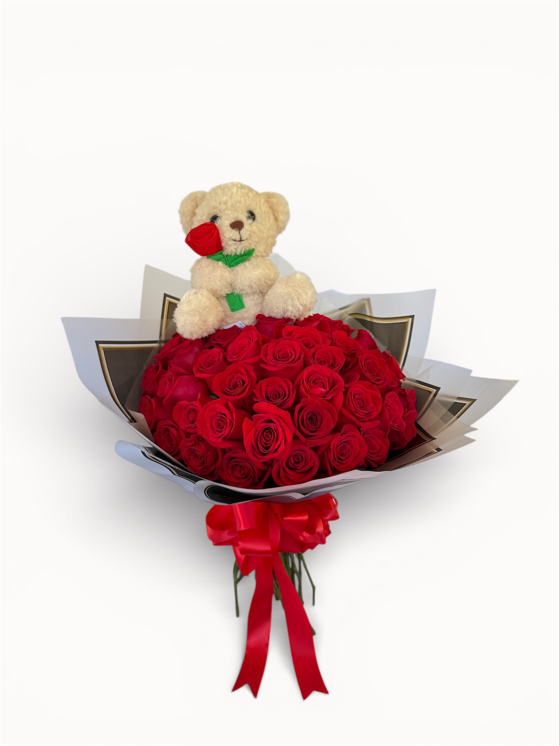 Bouquet of red roses with a teddy bear topper and red ribbon
