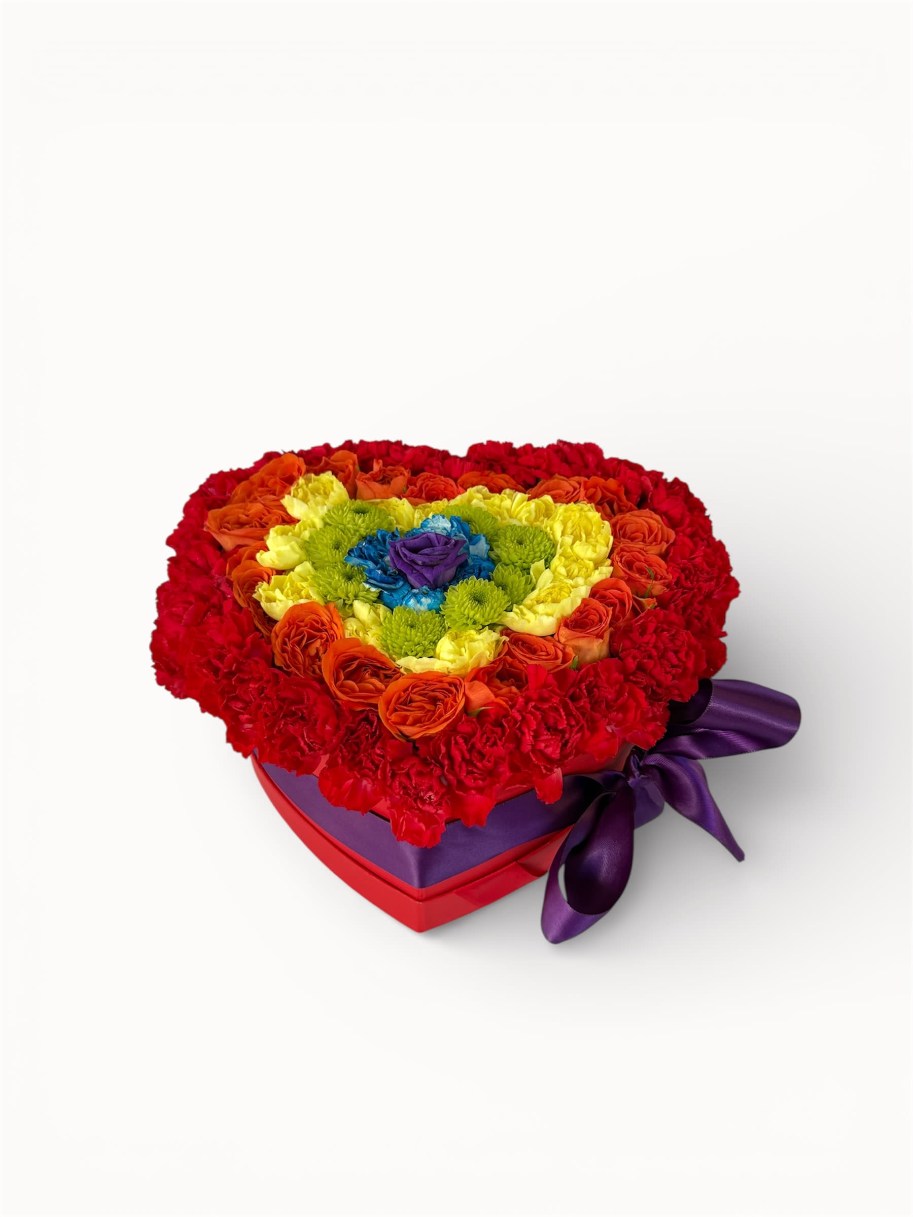 Heart-shaped box of multicolored roses and carnations with a purple ribbon