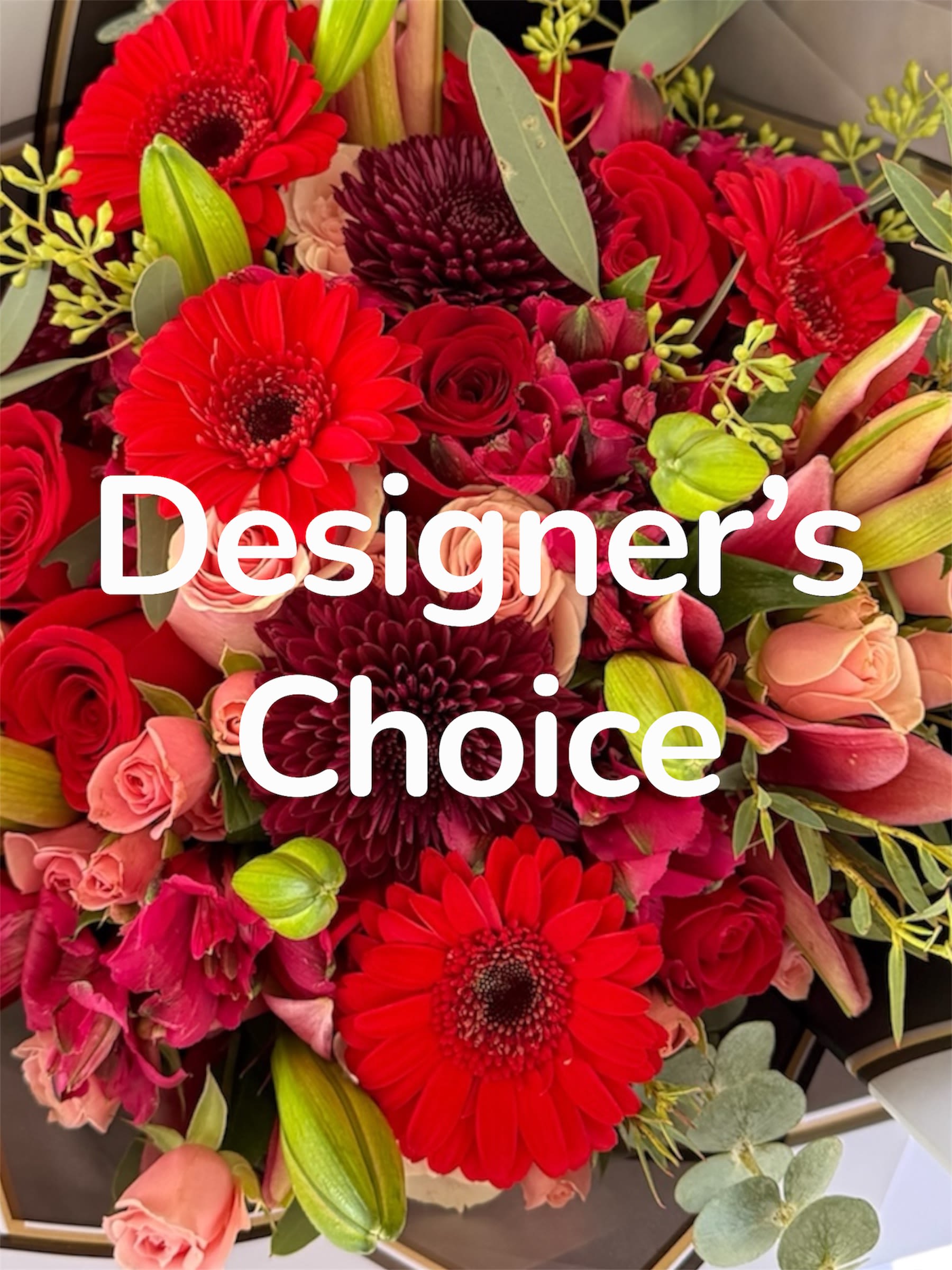 Bouquet of red gerbera daisies, roses, and pink blooms