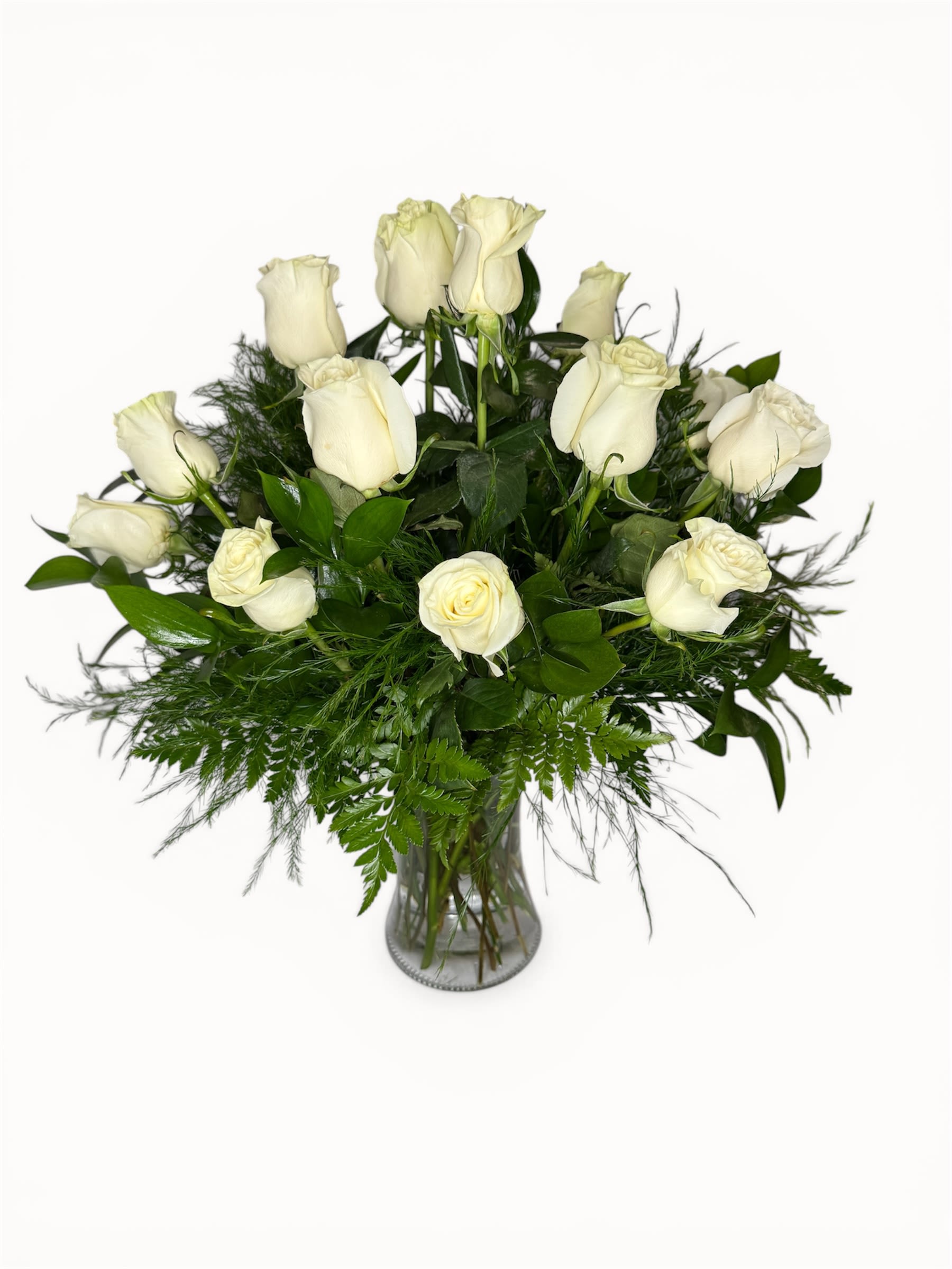Blanc Roses - 12 white roses gracefully arranged with greens and filler accents in a glass modern vase.