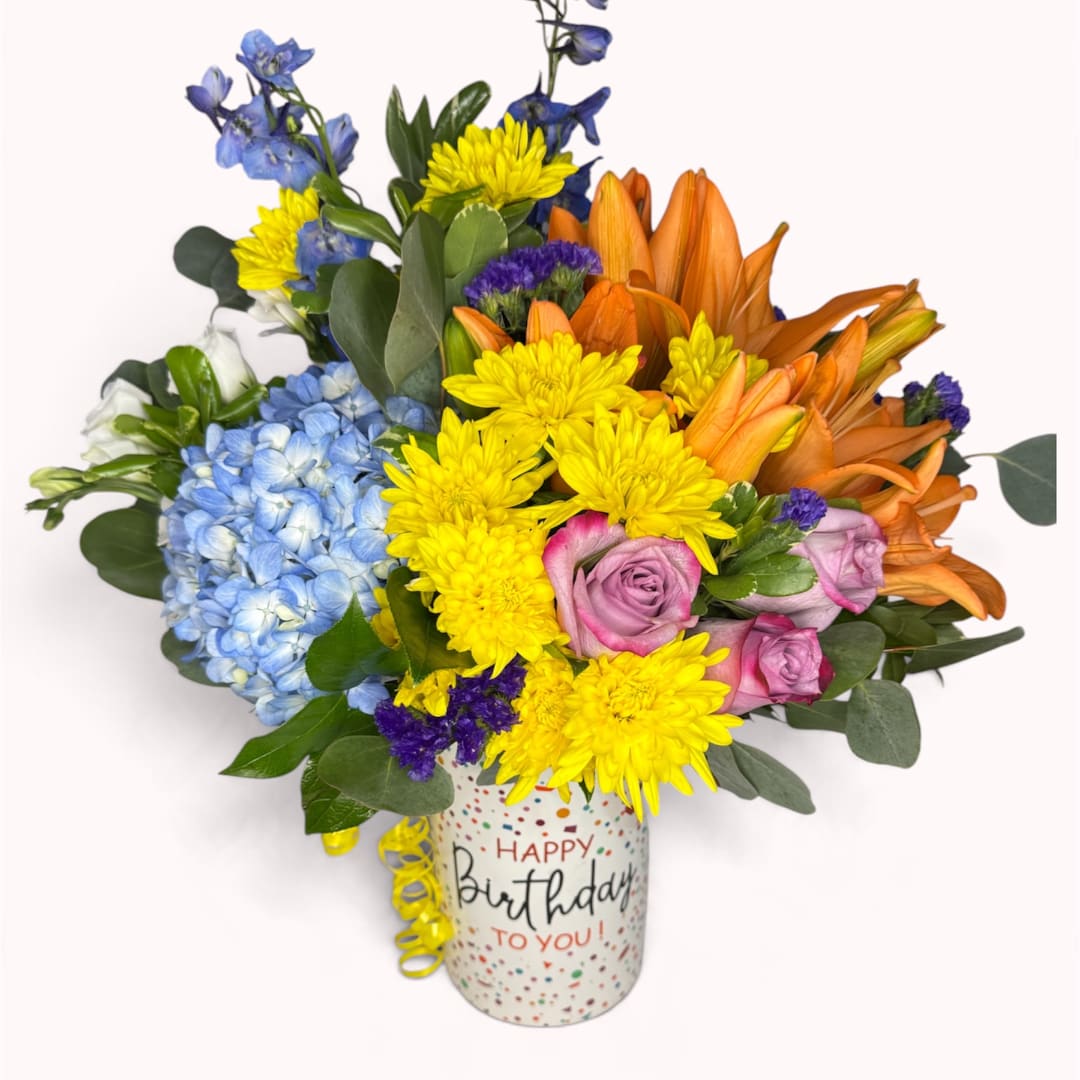 Colorful birthday bouquet in a decorated mug vase