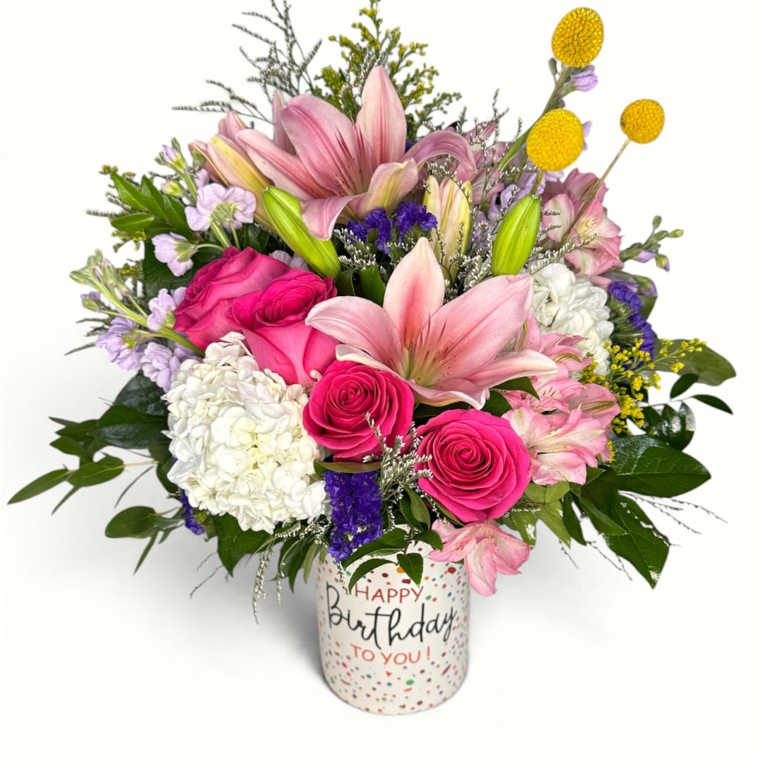 Pink lilies and roses in a birthday vase with mixed flowers
