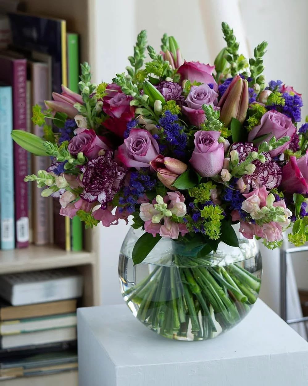Mystic purple garden  - This fish bowl arrangement showcases vibrant purple flowers arranged i a unique glass sphere,symbolizing mystery,luxury and elegance.