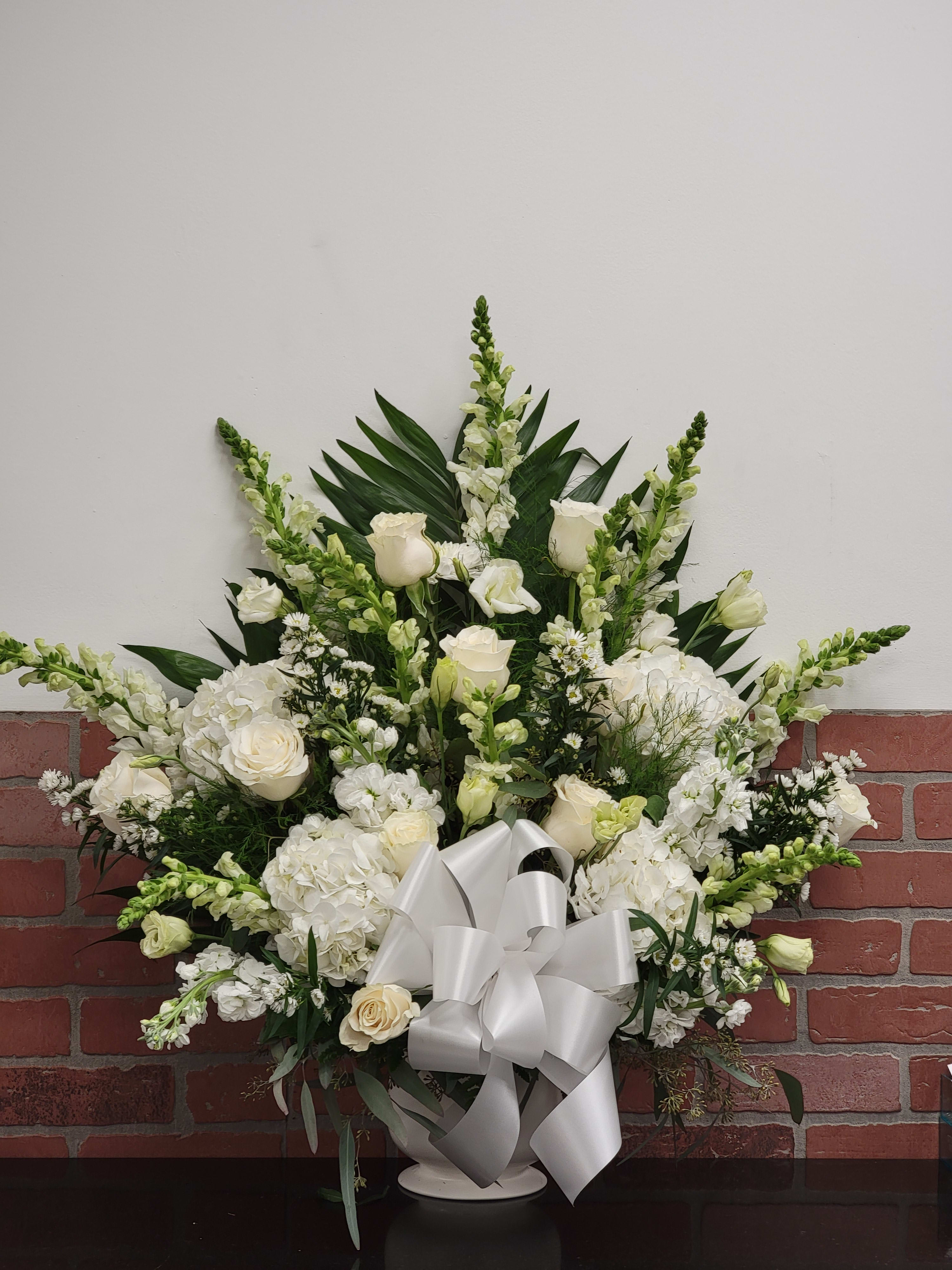 Sweet Comfort by Manny ™ - An all white tribute, this funeral basket is pure and tranquil. Featuring a variety of white flowers and greenery, this design reaches for the sky and evokes a feeling of peace upward and outward. 