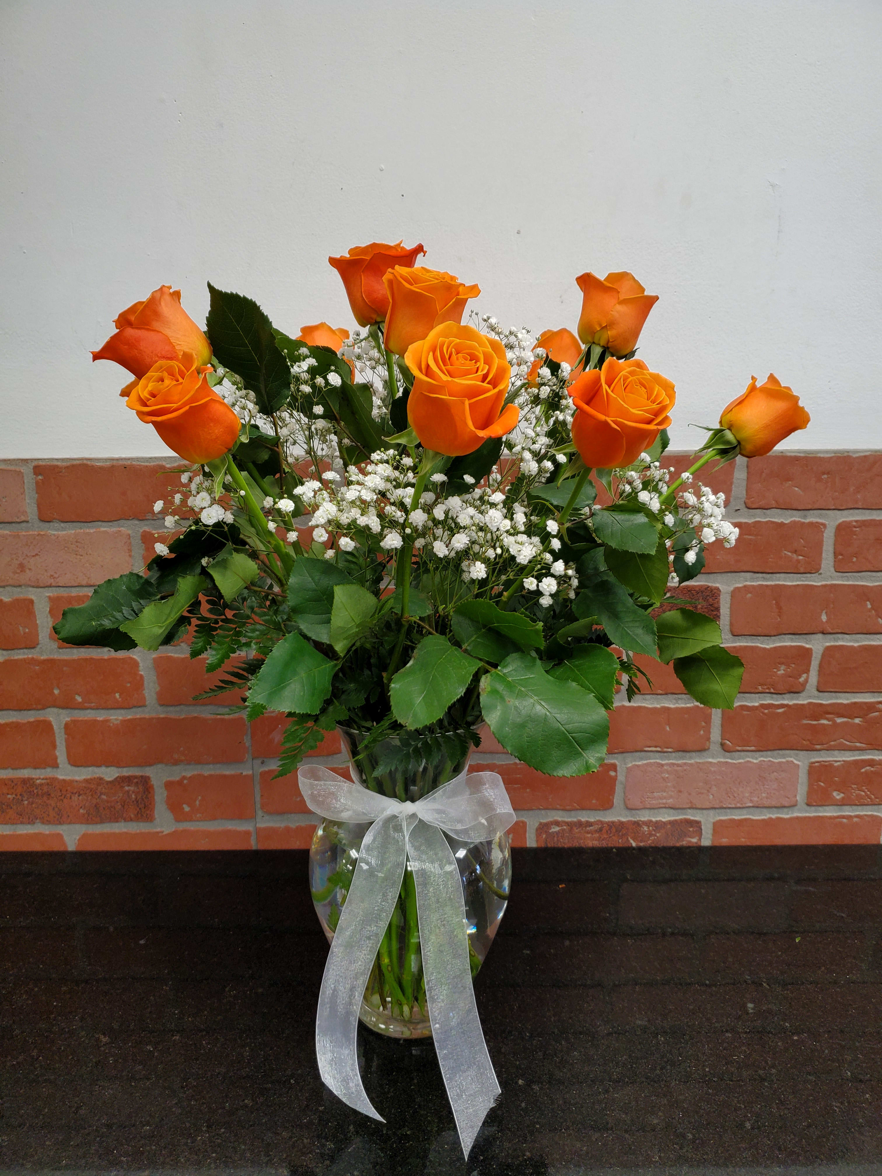 Dozen orange roses  - Brighten someone's day with a touch of color, perfect for summer. Standar size 12, deluxe size 18 and premium size 24 roses.