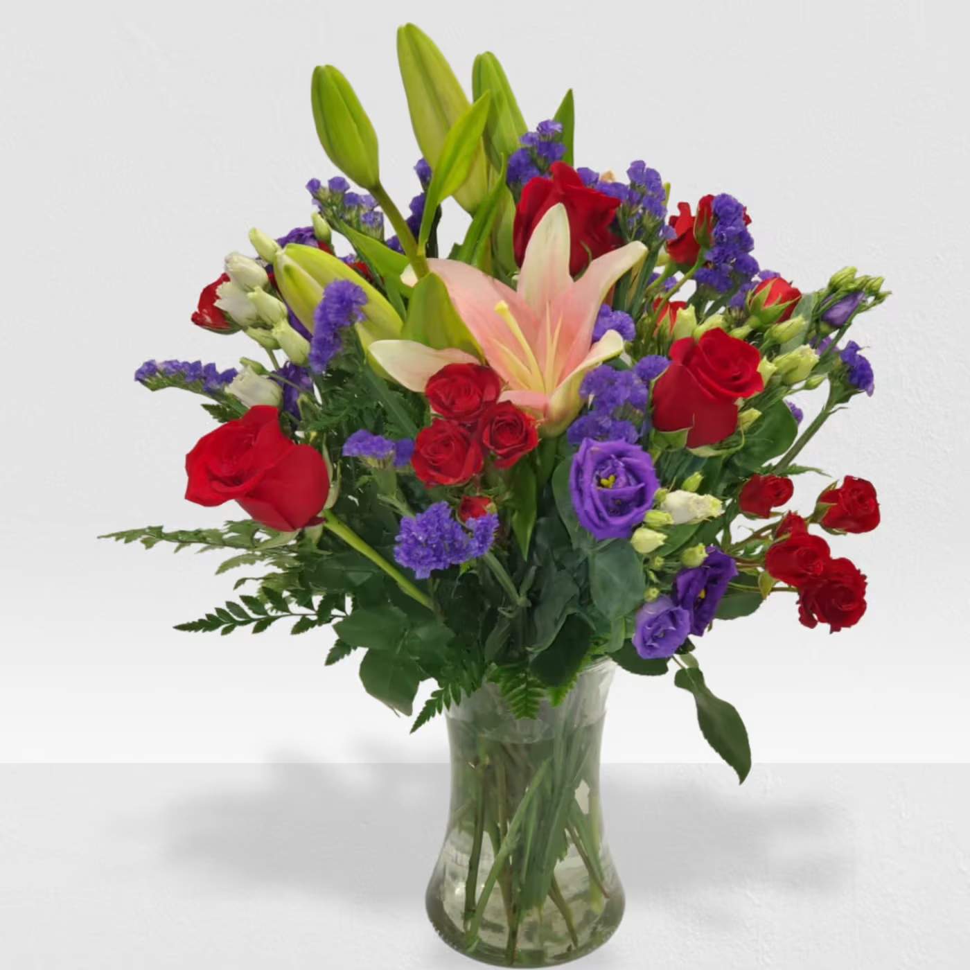 Truly Stunning bouquet by Manny - Red and purple flowers a very passionate flowers mix in a clear vase 
