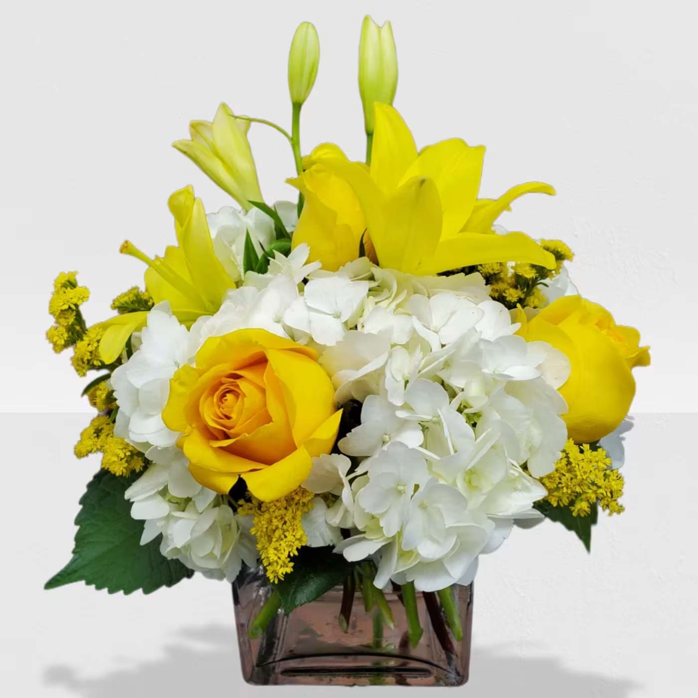 Kiss of the Sun by Manny  - Bring the sunshine to someone's day with the gorgeous, fragrant bouquet. This arrangement contains asiatic lilies, spray roses, and hydrangea. It is the perfect gift for someone's birthday or to uplift someone's spirits. APPROXIMATE DIMENSIONS: 9"L X 9"W x 9"H