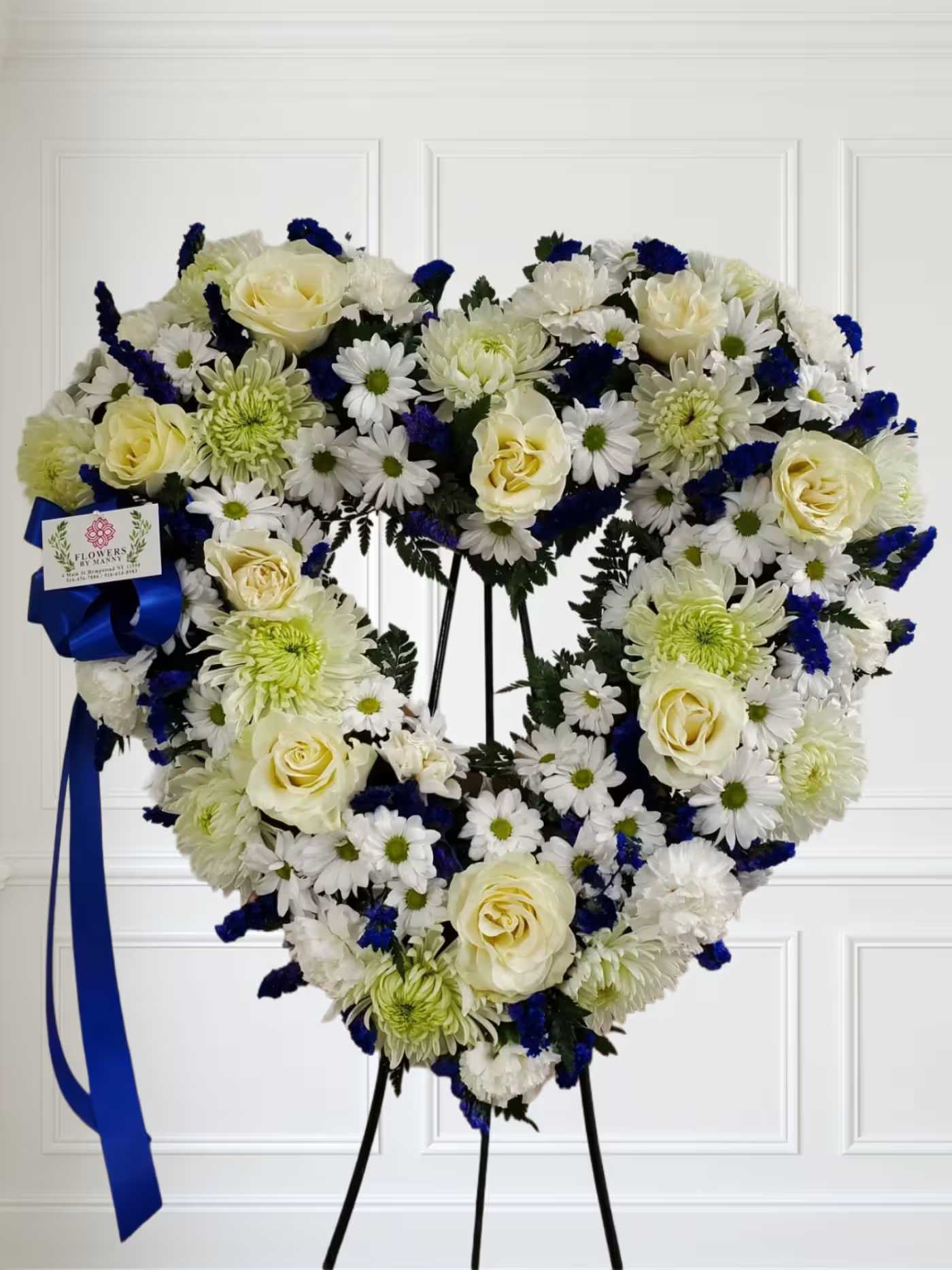 Blue and white open heart - White mixed flowers and touches of blue.