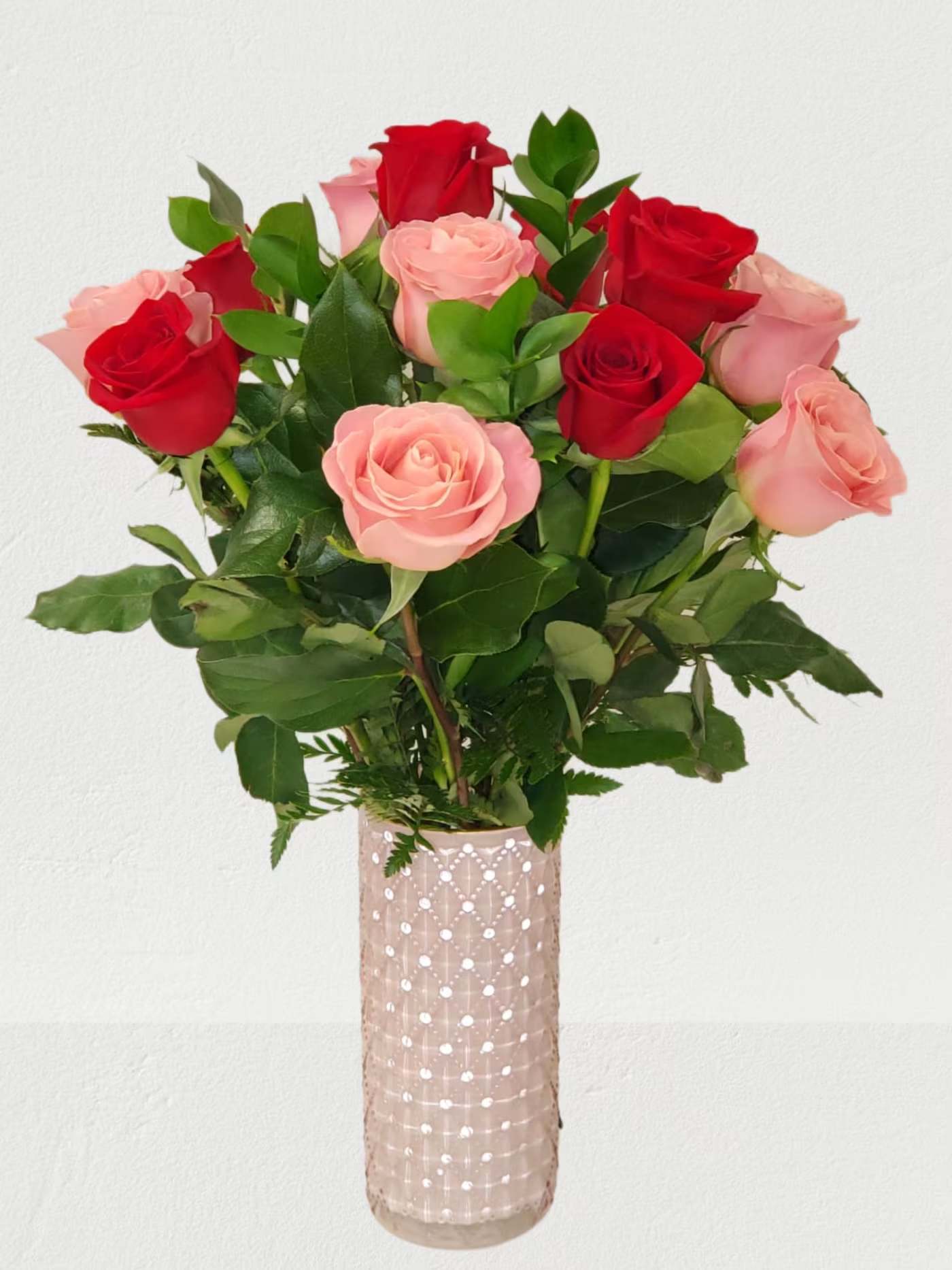 Bouquet of red and pink roses in a decorative vase