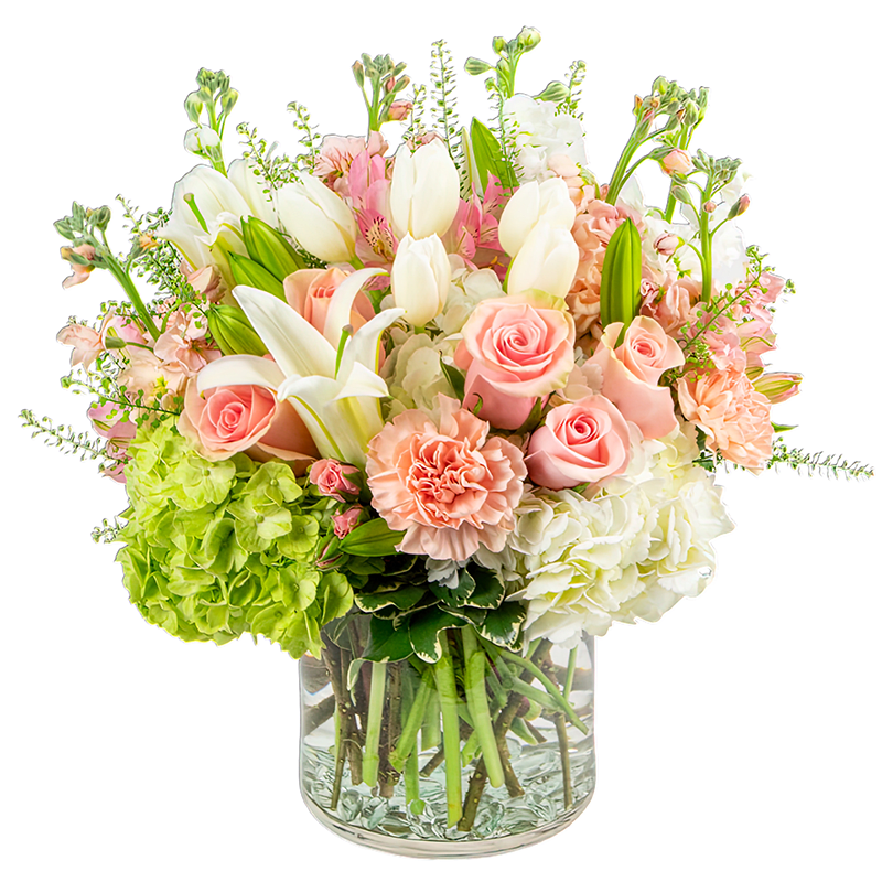 Pink roses and white lilies in a clear glass vase