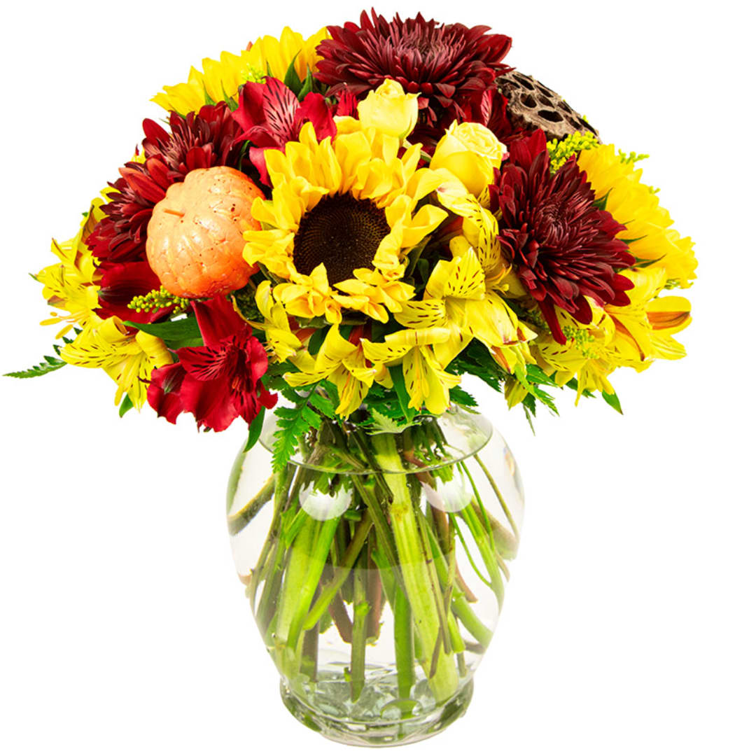 Bouquet of yellow and red flowers in a clear glass vase