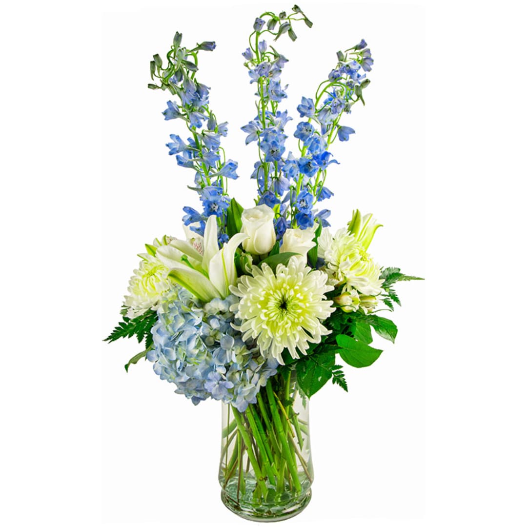 Blue and white flowers arranged in a clear glass vase