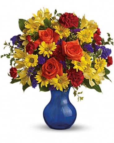 Colorful bouquet of roses, daisies, and carnations in a blue vase